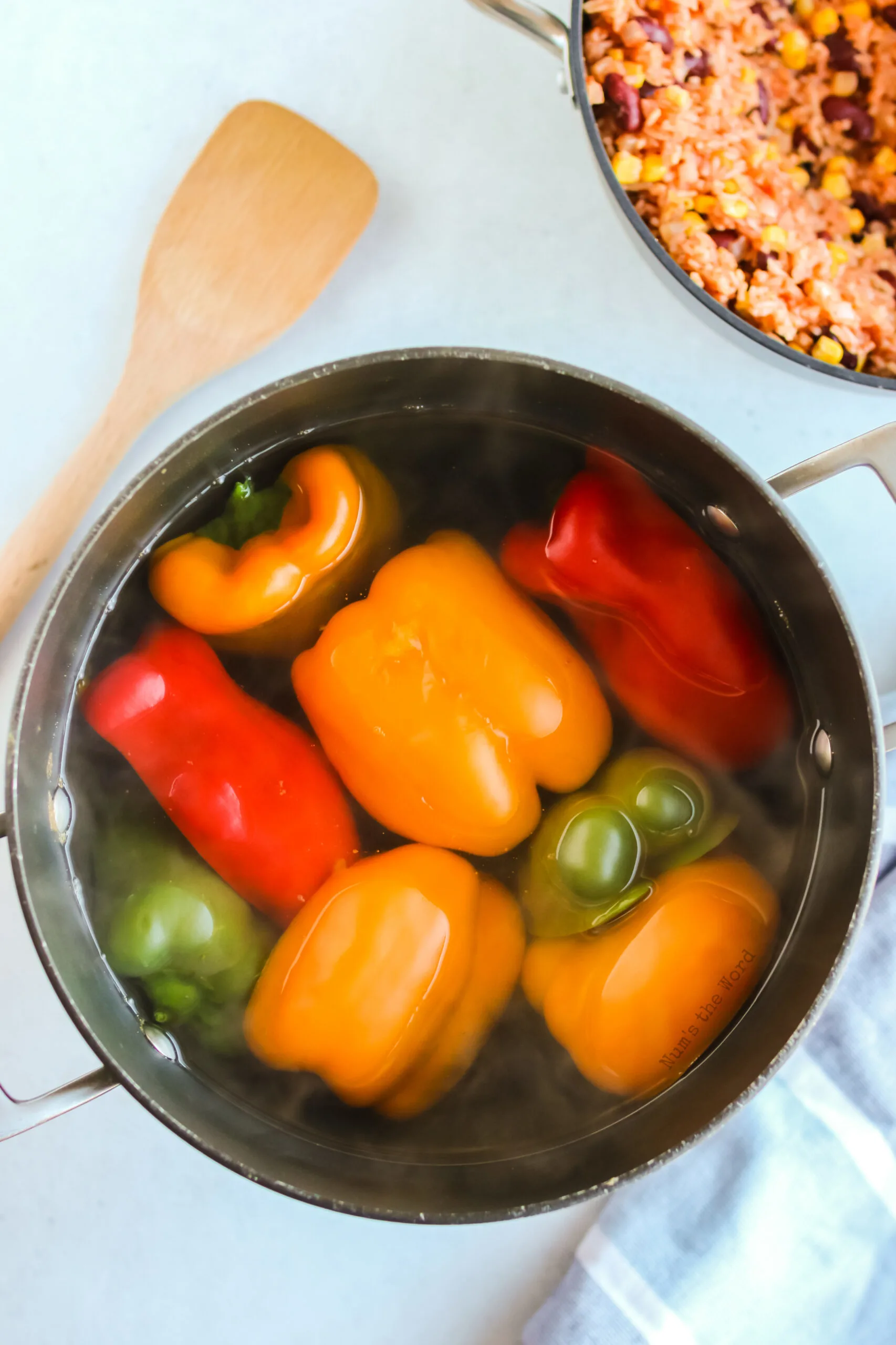 peppers cut in half and in a pot of boiling water.