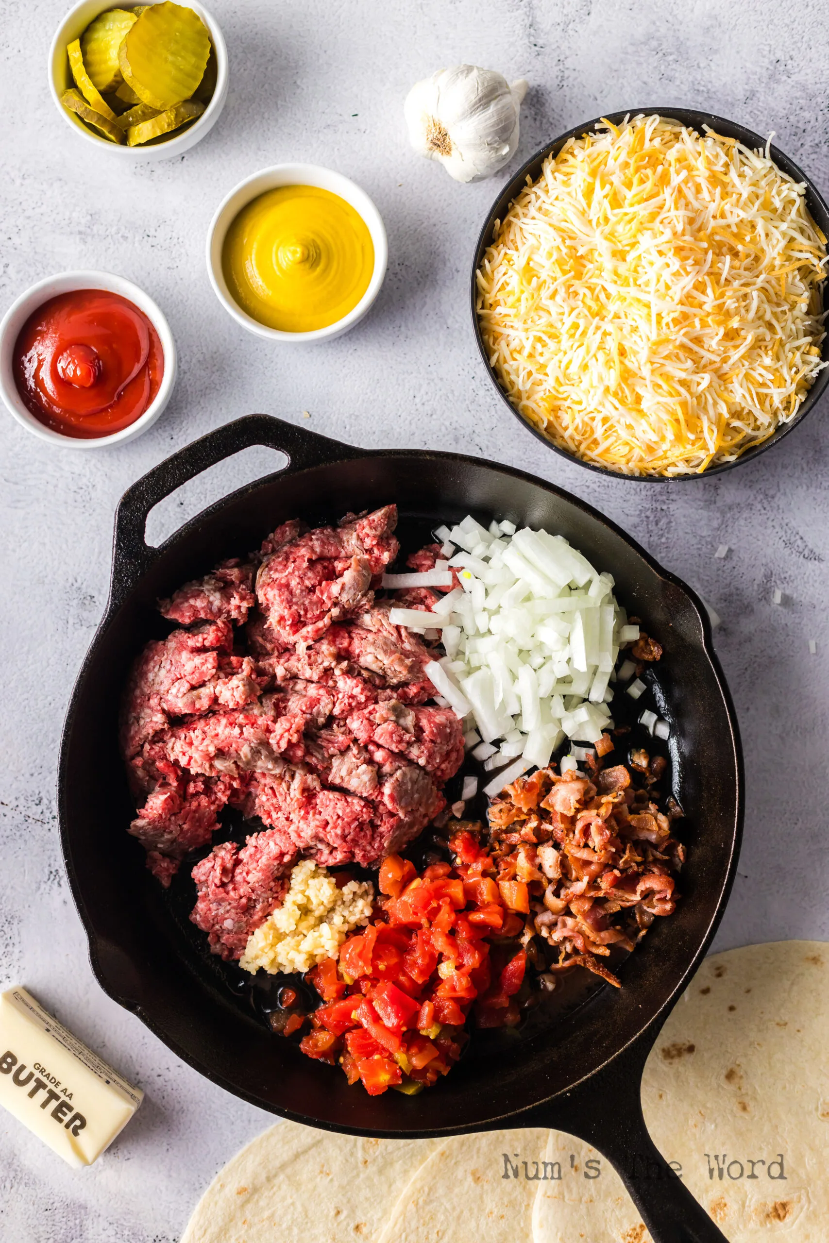 Ground beef, bacon, onion, garlic and rotel added to a skillet