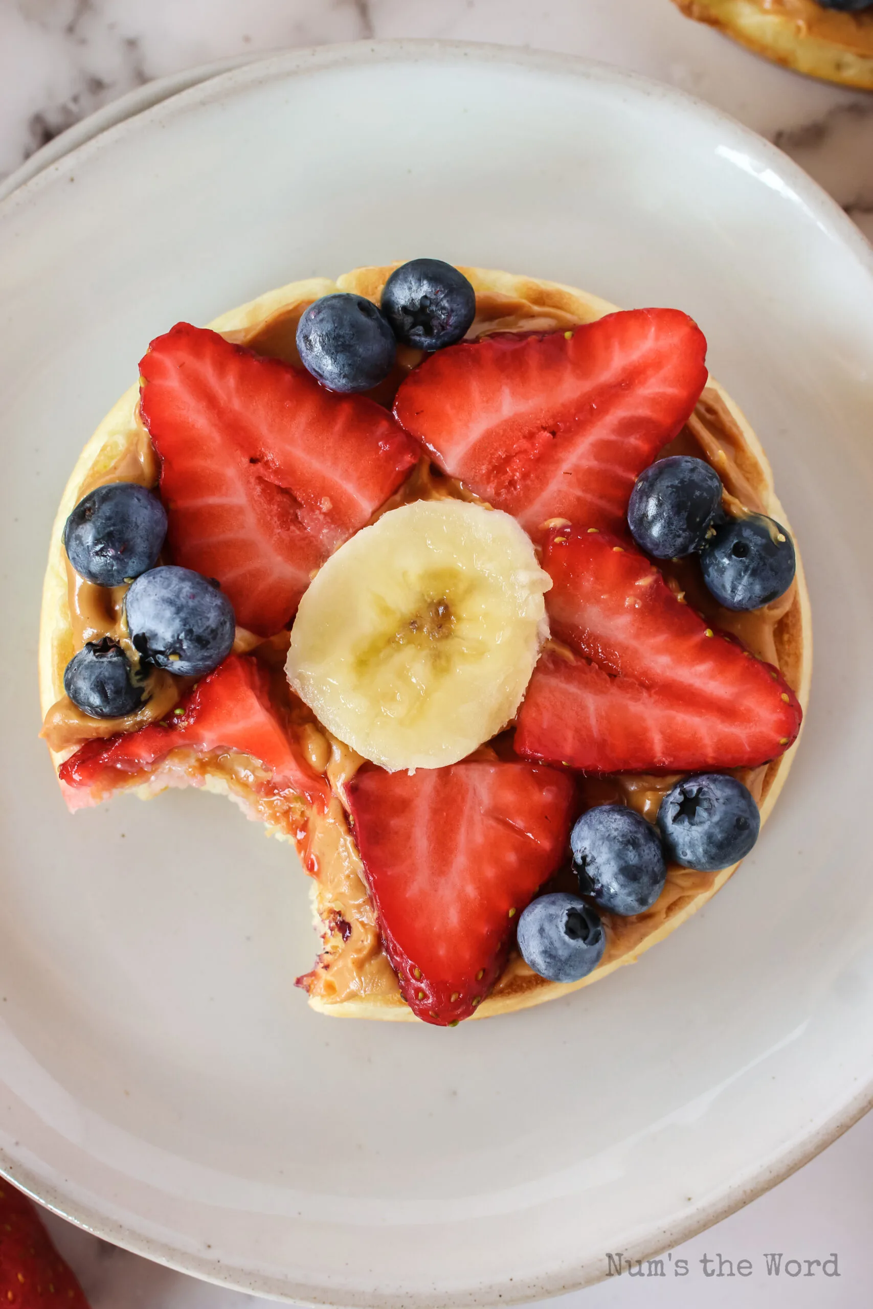 top view of eggo fruit pizza with a bite taken out of it