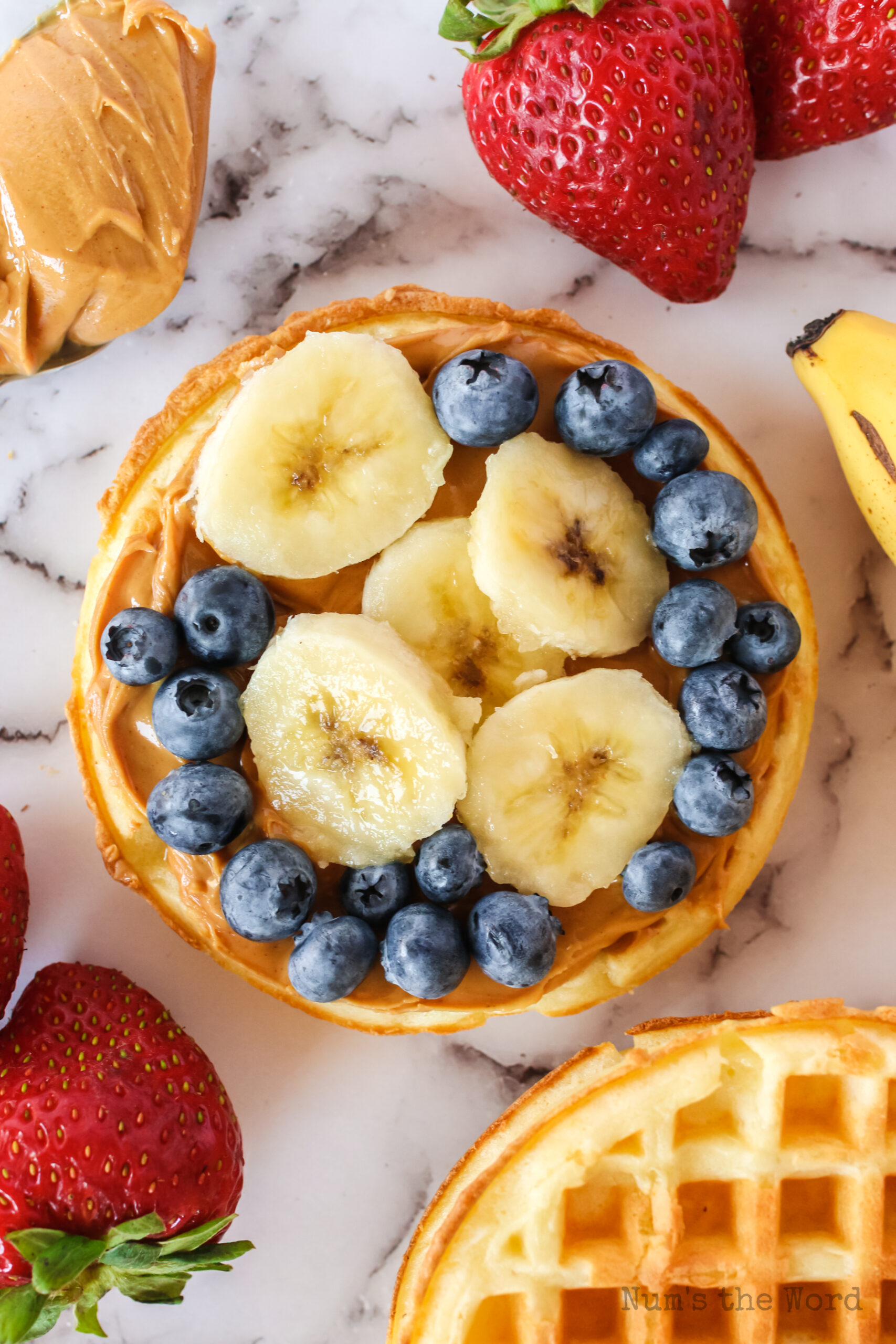eggo pizza with sliced bananas and blueberries