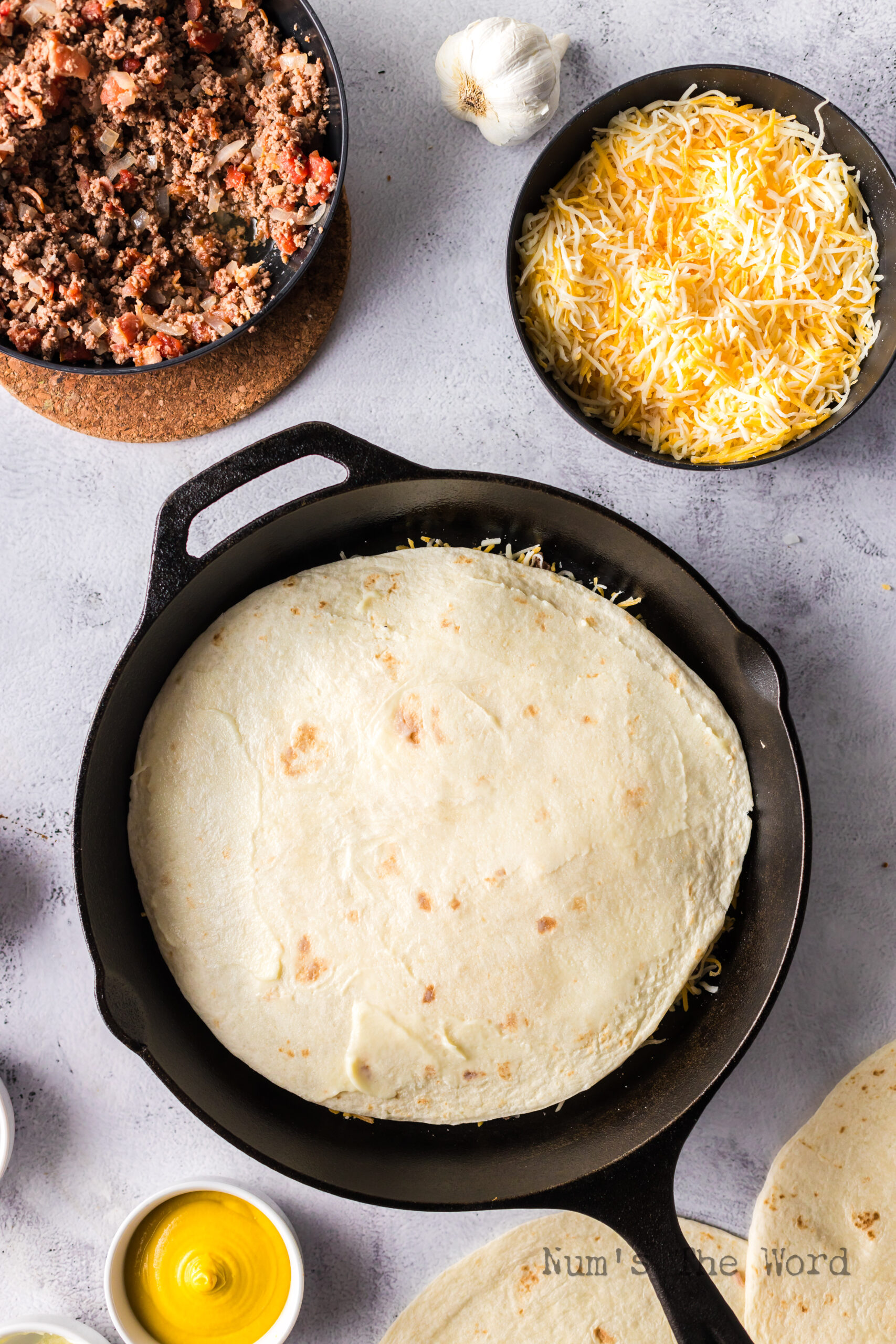 second tortilla on top of the quesadilla mix in skillet