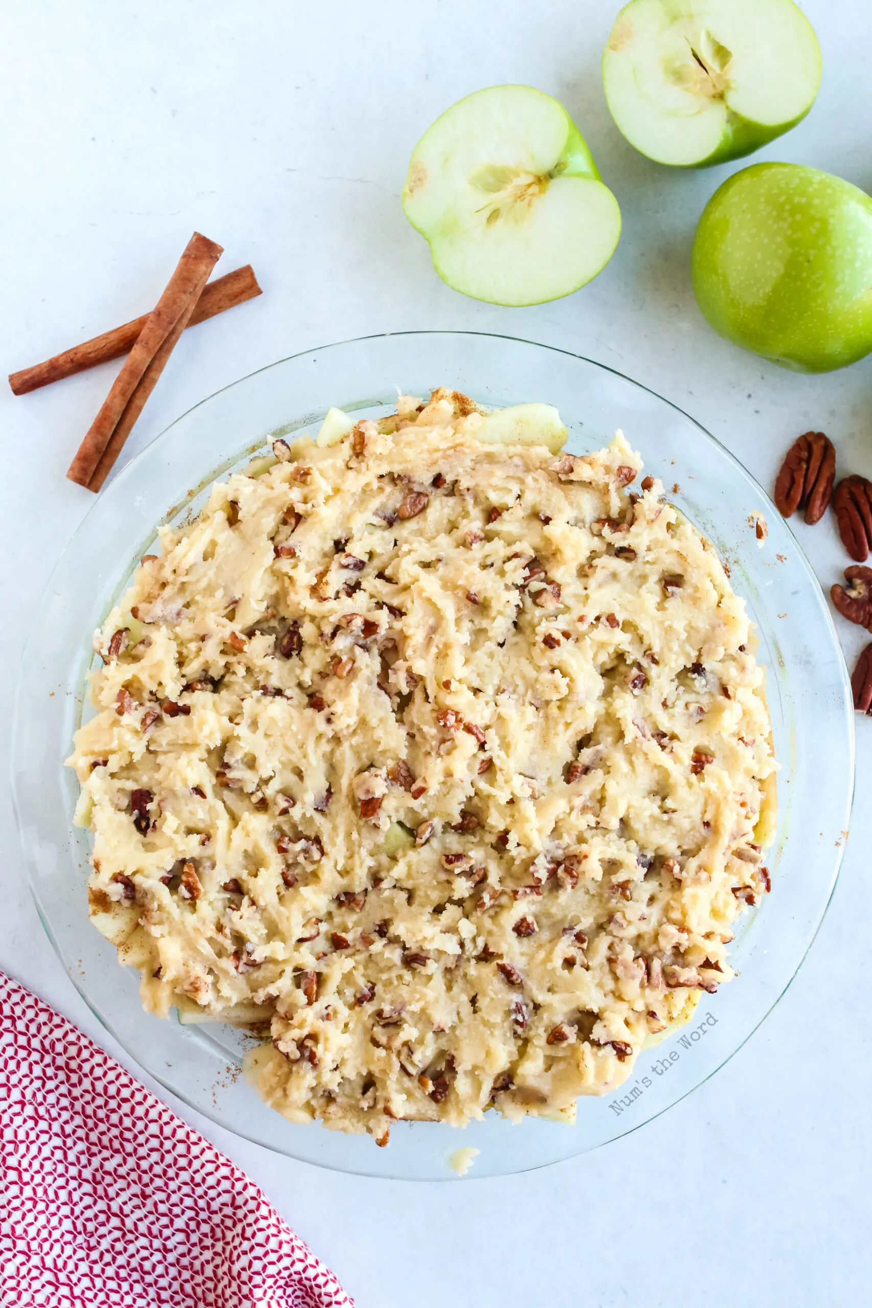 Pie crust batter spread on top of apples