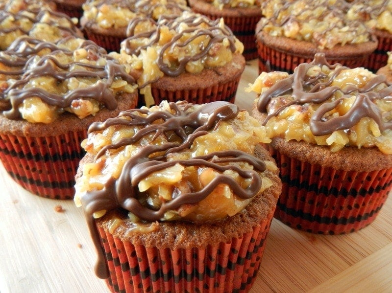 German Chocolate Cupcakes - German Chocolate Frosting topping the cupcakes with a chocolate drizzle!