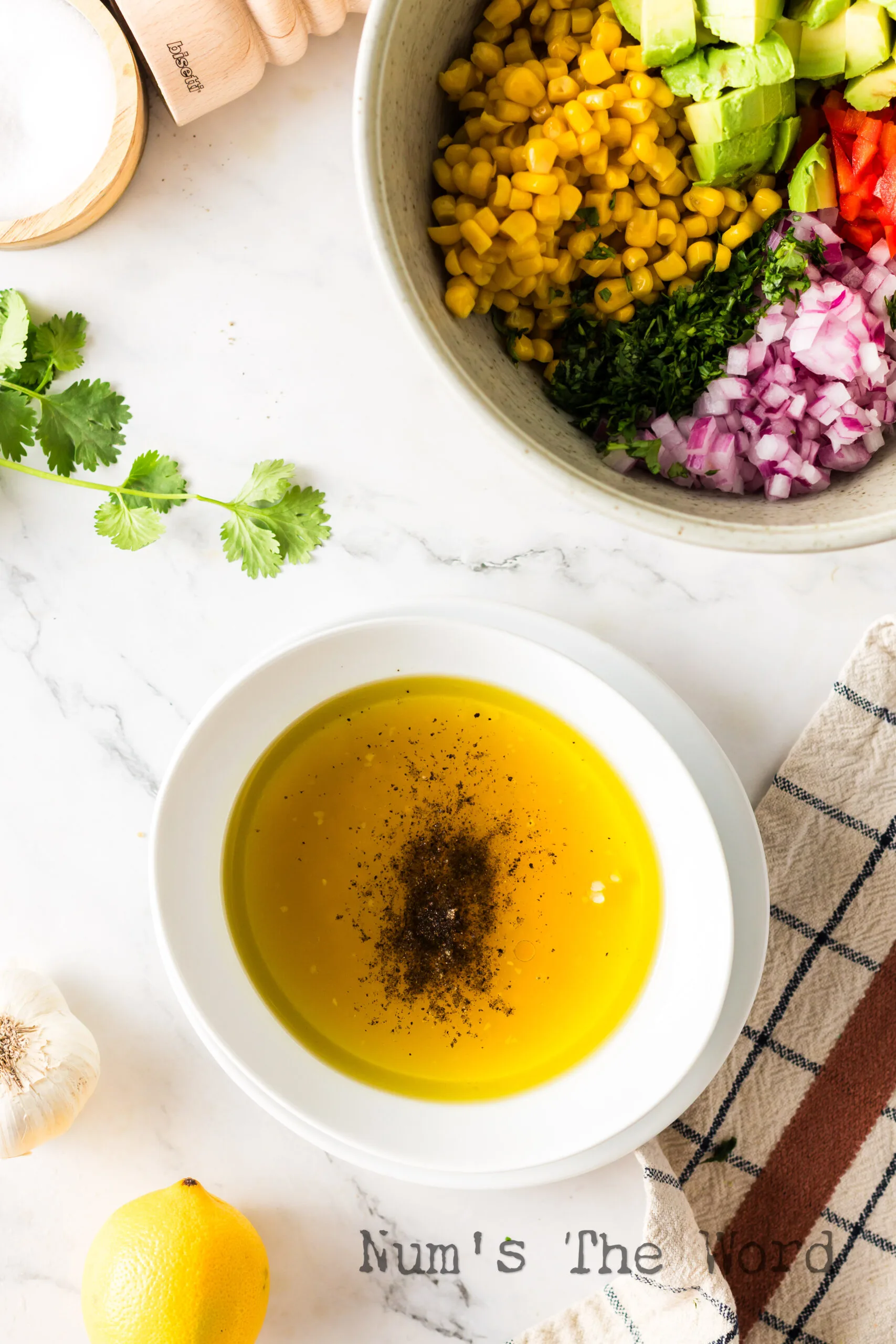garlic, olive oil, lemon juice, vinegar, salt and pepper in a bowl, unmixed.