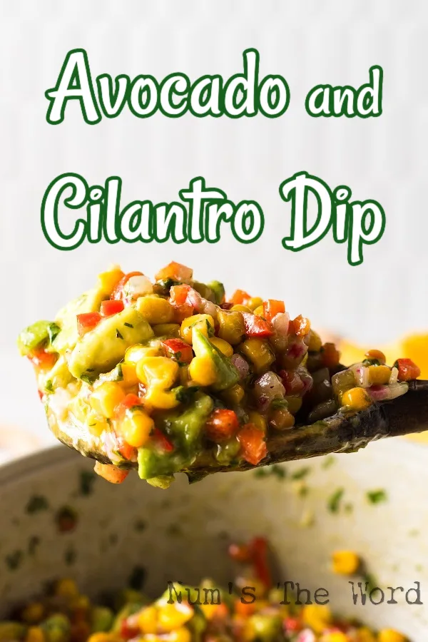 Main image for Avocado and Cilantro Dip. Wooden spoon scooping out a portion of avocado and cilantro dip. 