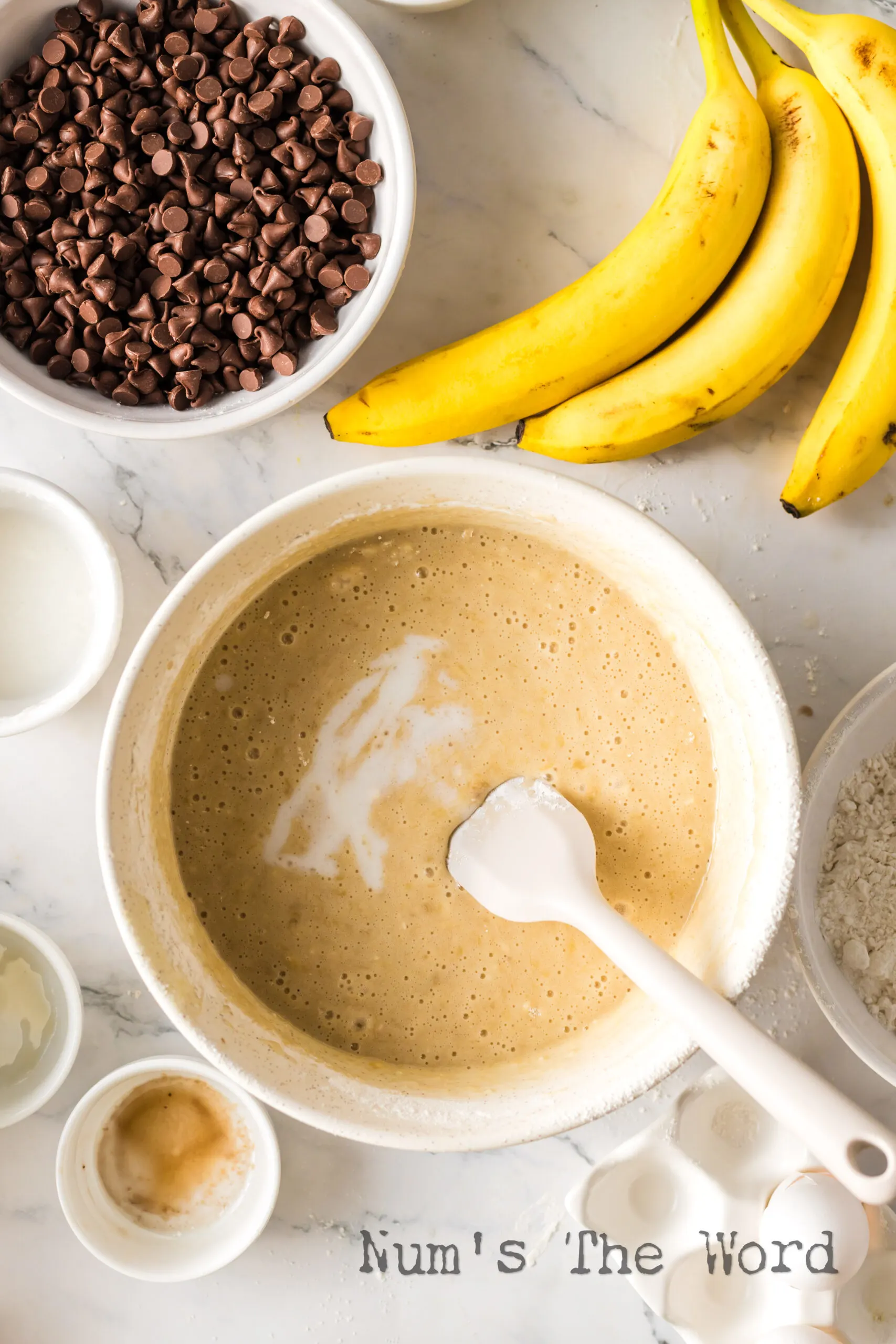 Muffin batter on counter without coconut or chocolate chips.