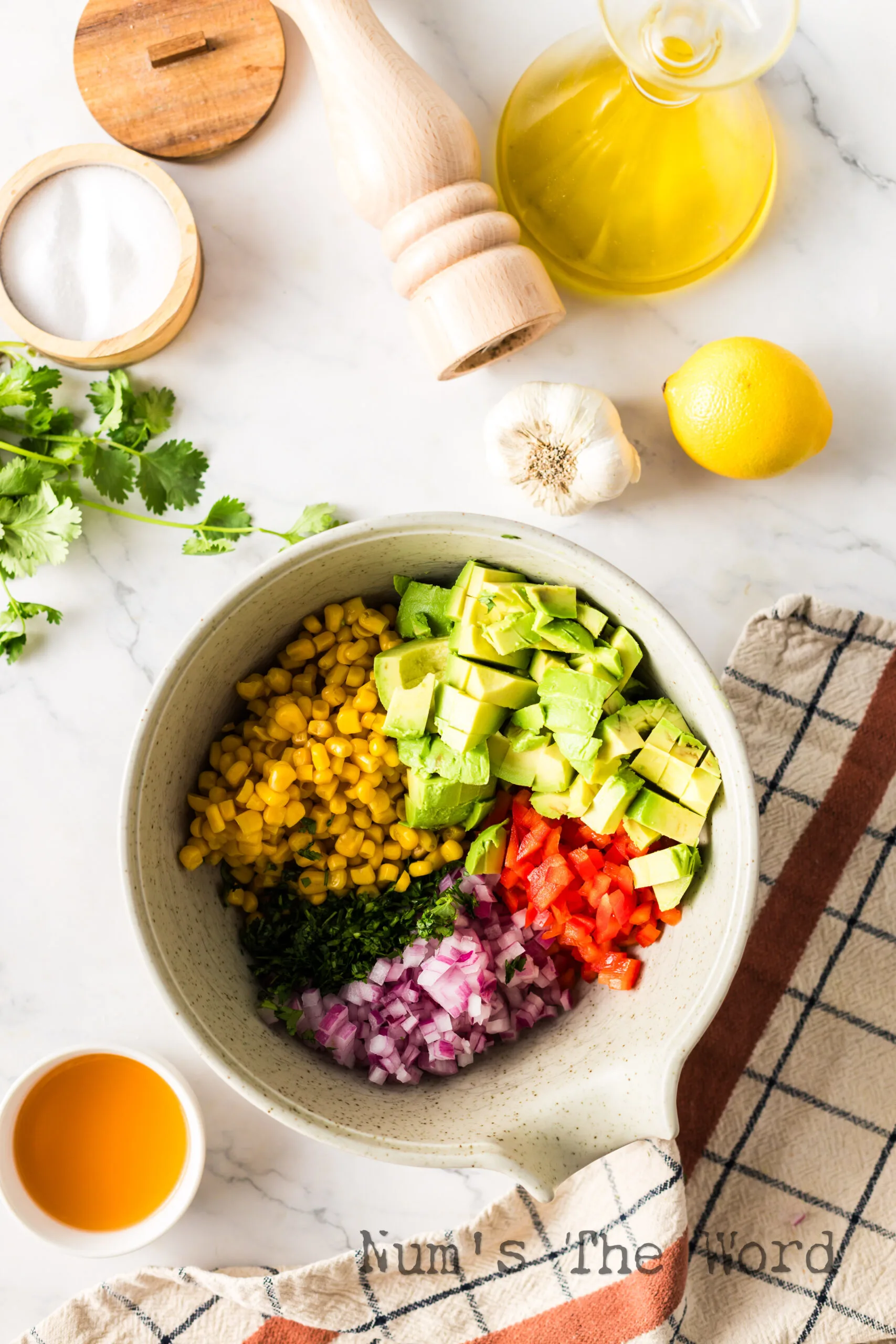 corn, bell pepper, onion, cilantro and avocado in a bowl, unmixed.