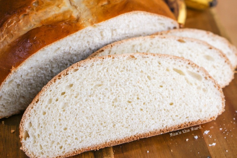 Banana Yeast Bread - Bread sliced with slices in front of loaf. Photo taken from front and above bread.