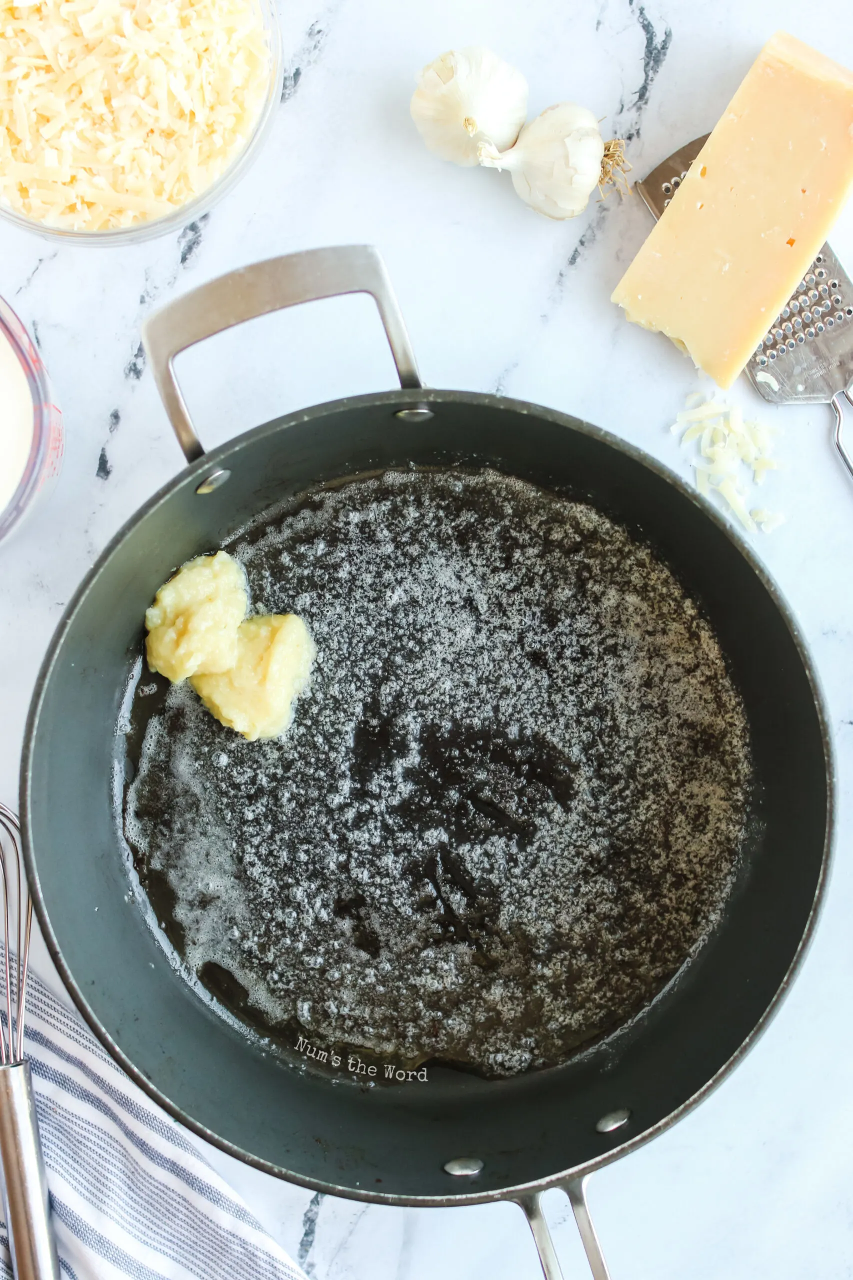 Butter and garlic in a skillet ready to be cooked.