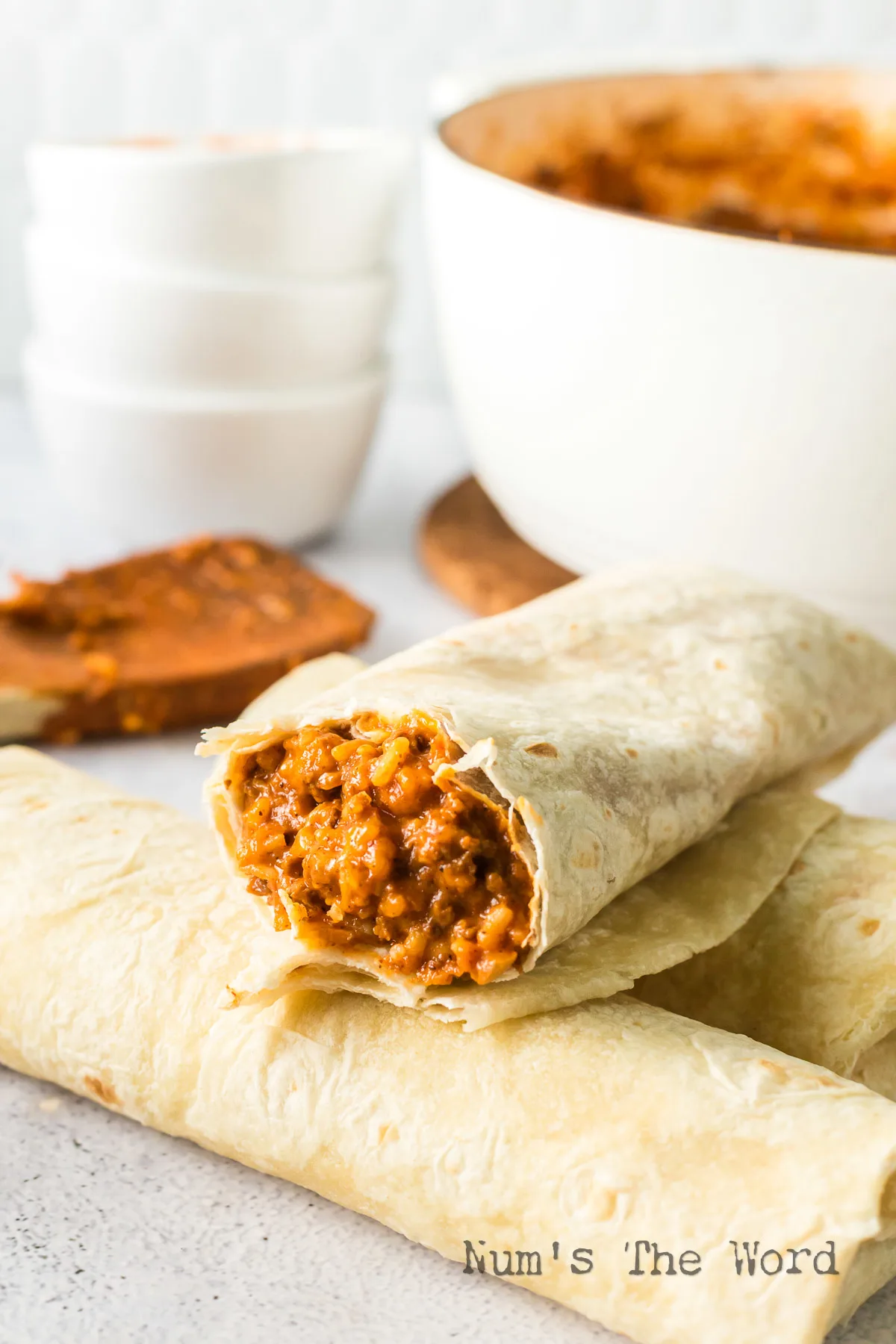 side view of burritos stacked up with filling showing.