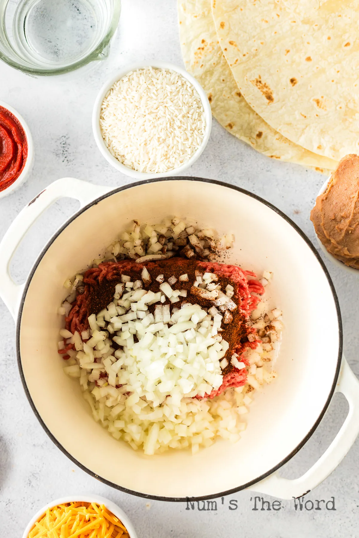 ground beef onions, chili power and salt all placed in a dutch oven.