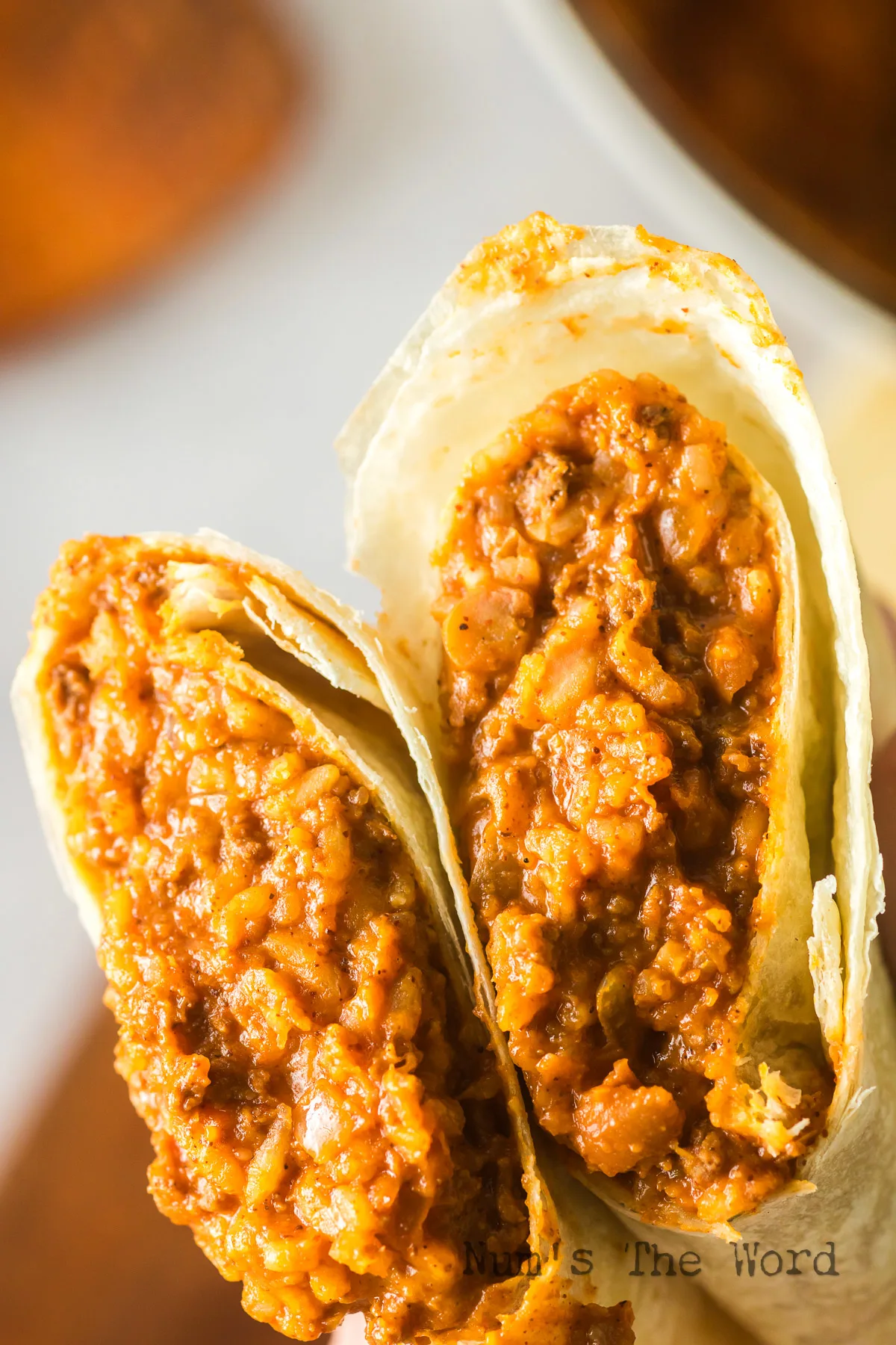 zoomed in image of burrito cut in half, showing filling.