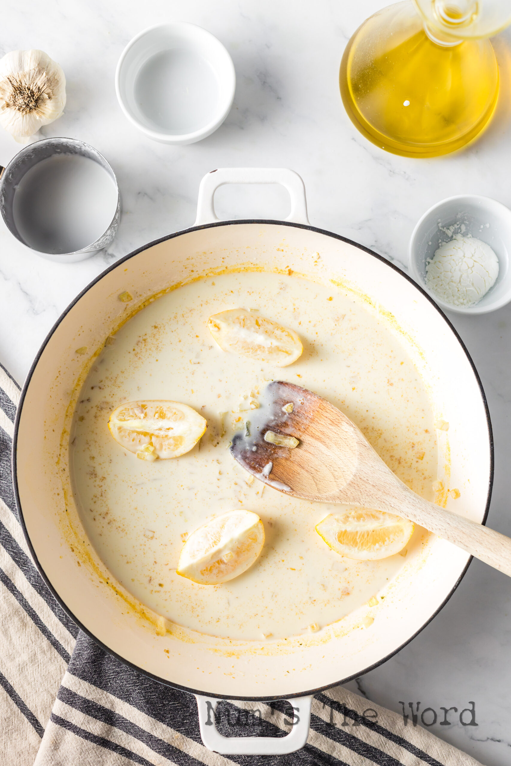 cream sauce cooking with lemon slices.