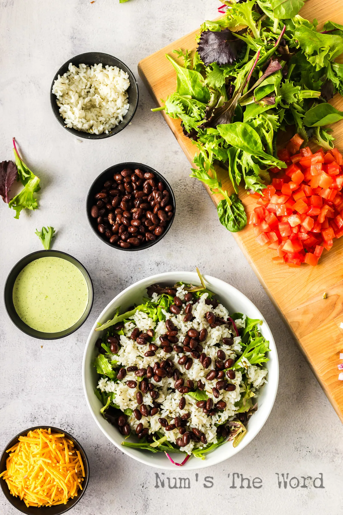 Black beans added on top of cilantro lime rice in bowl.