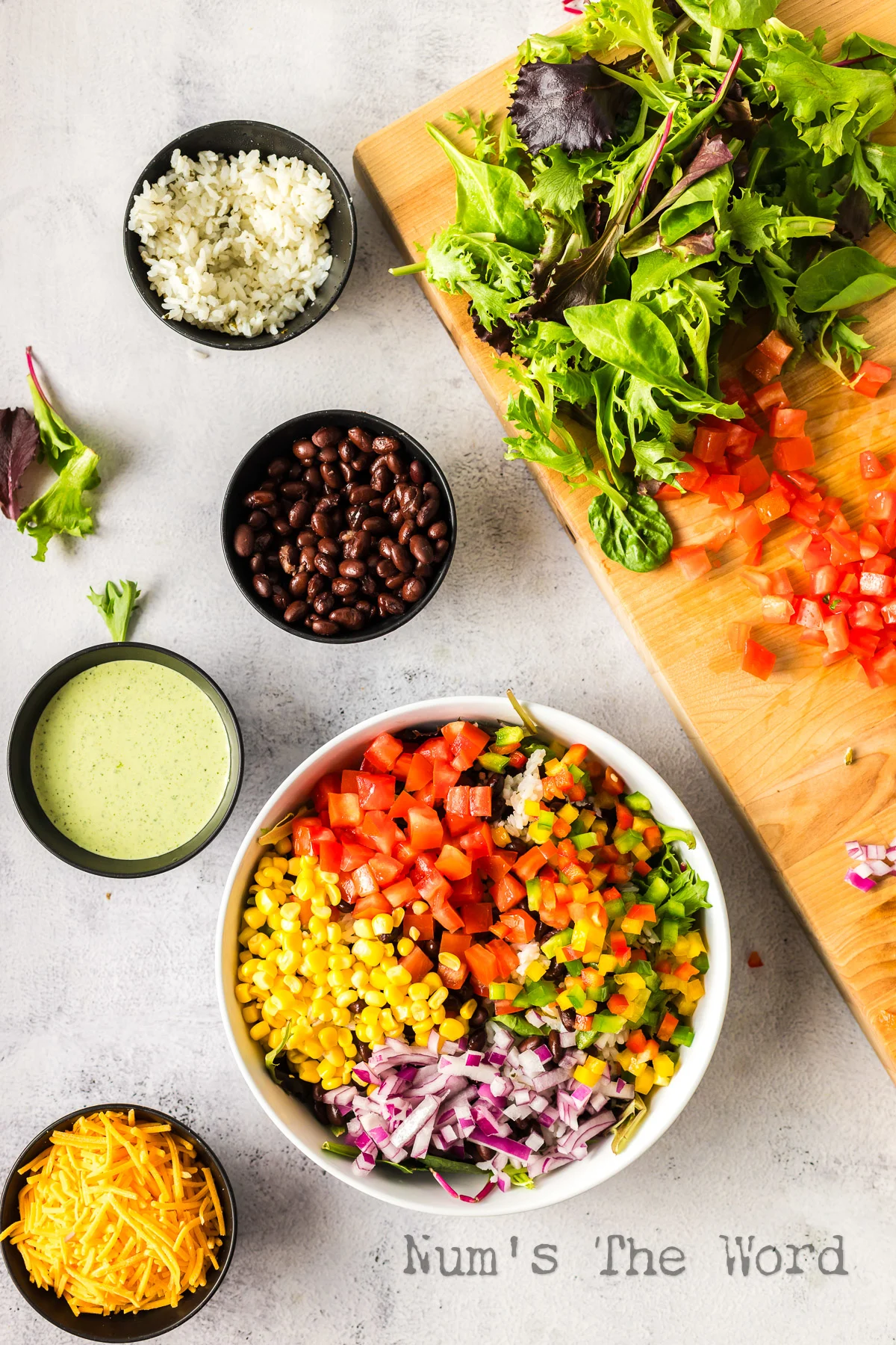 diced bell peppers and red onion added to salad bowl.