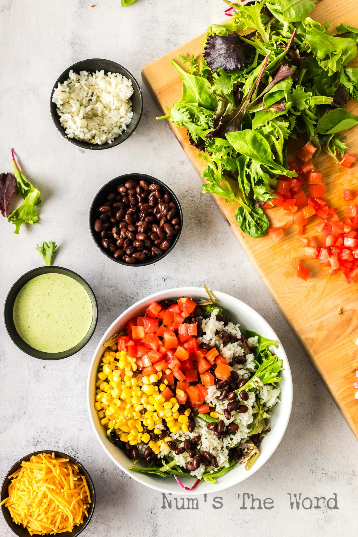 Corn added to bowl with tomatoes and rice.