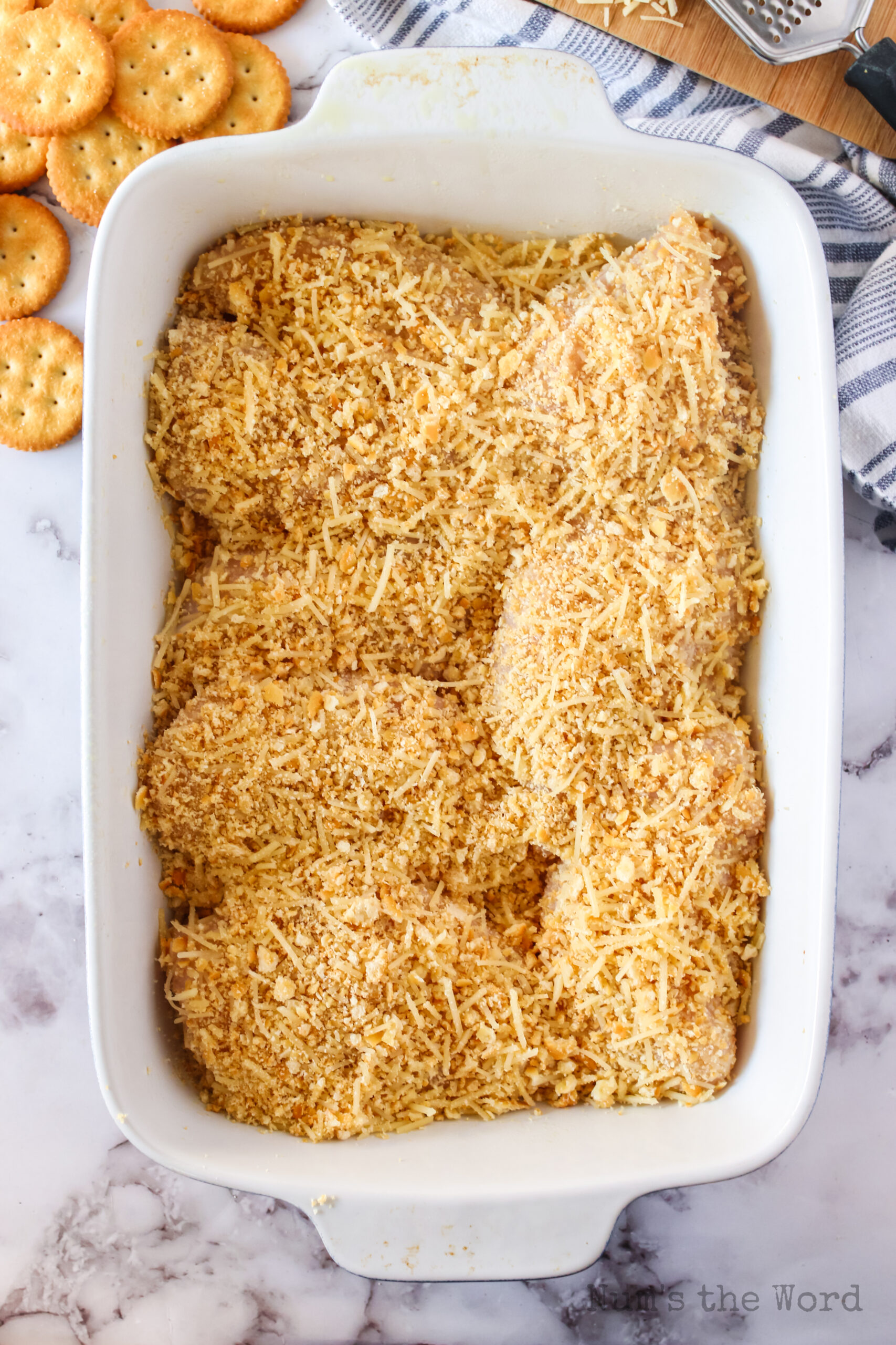 8 pieces of chicken covered in ritz crackers and cheese and put into casserole dish