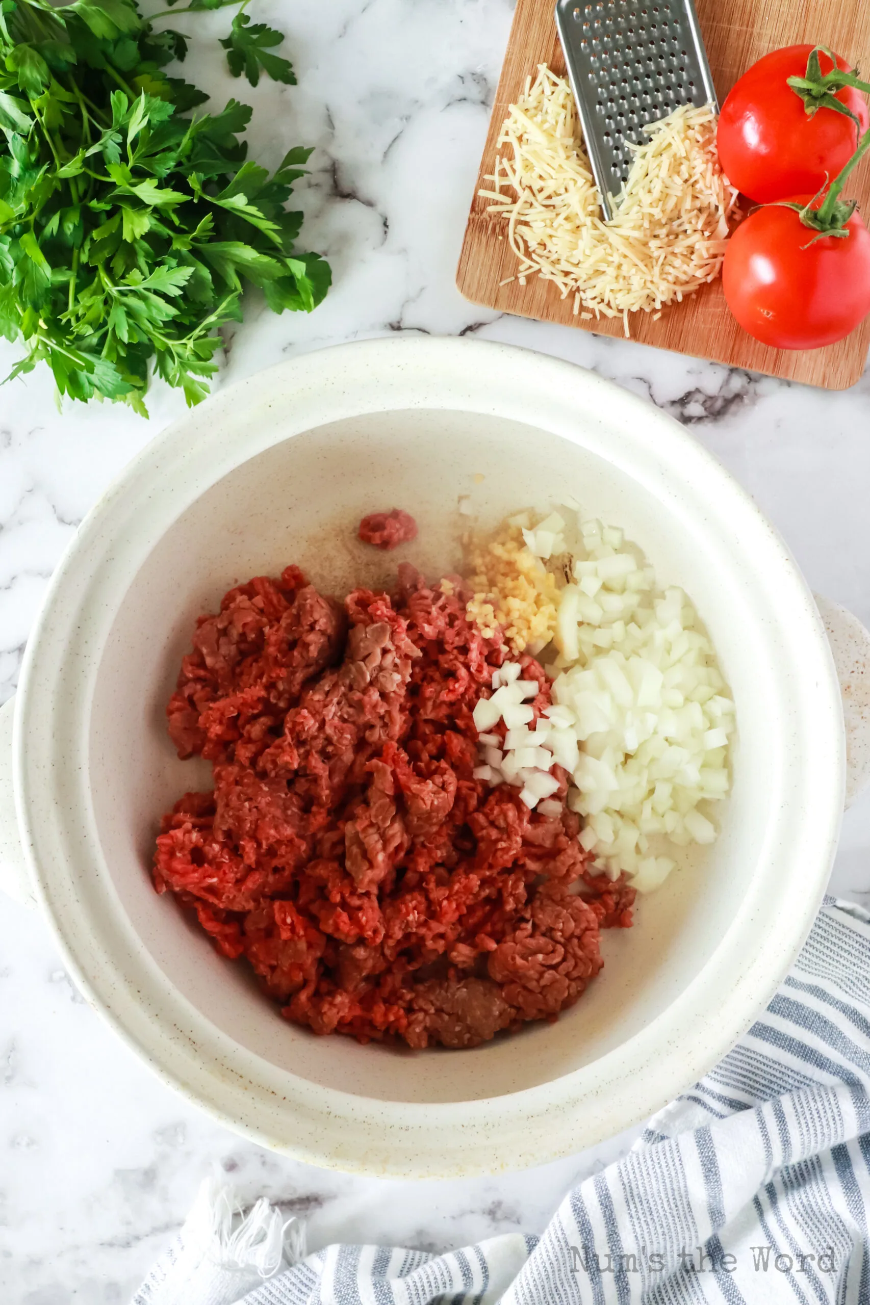 ground beef, onion and garlic in a pot, uncooked