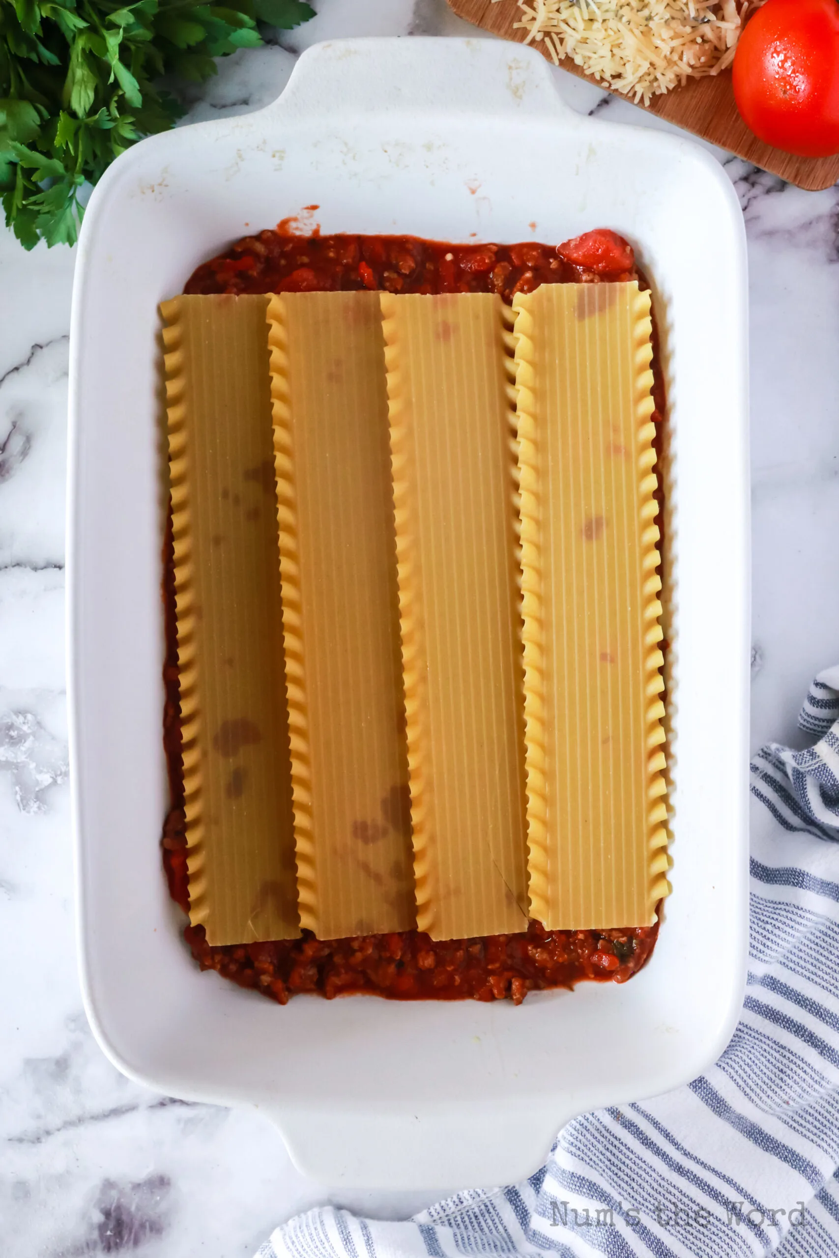 ready cook lasagna noodles placed on top of ground beef mixture.