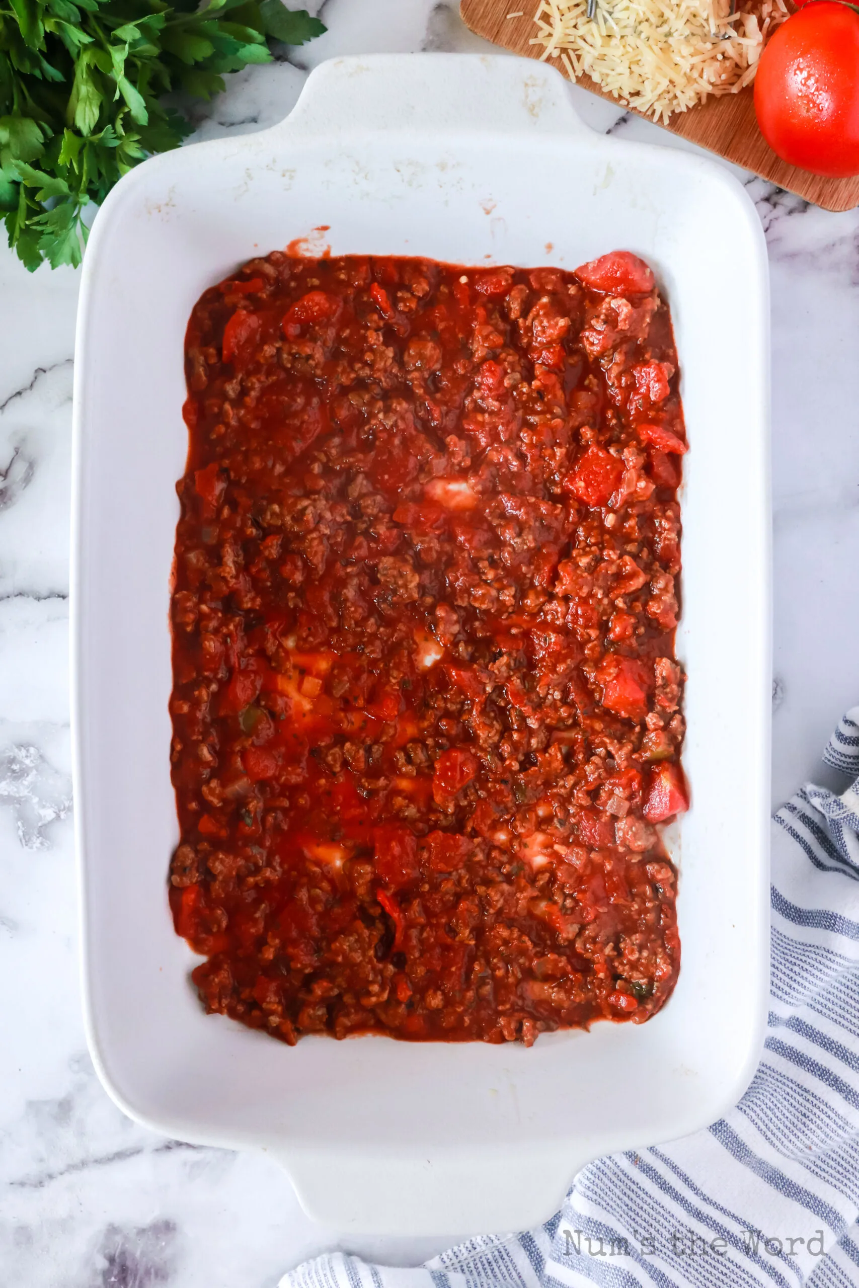 ground beef mixture placed in the bottom of a casserole dish.