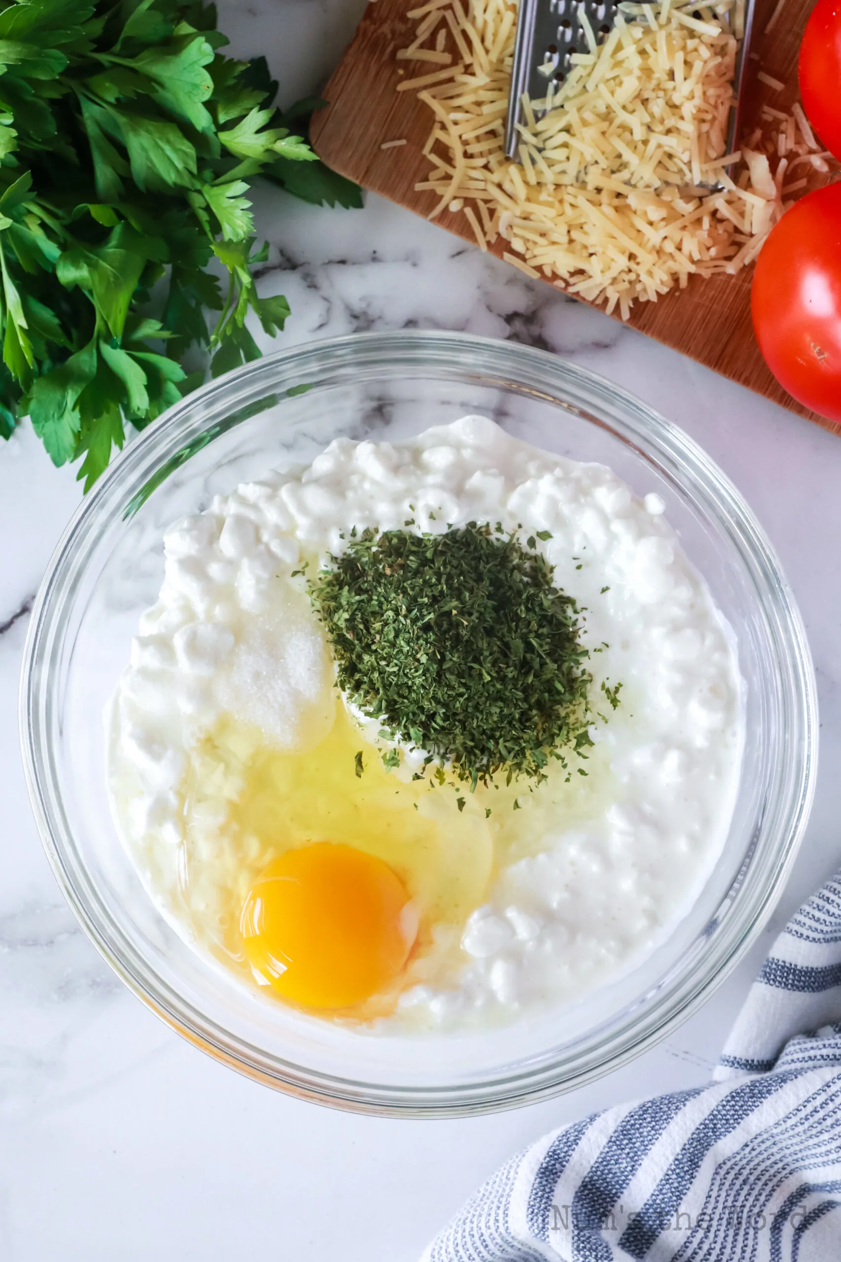 cottage cheese, egg, parsley and salt in a bowl, unmixed.