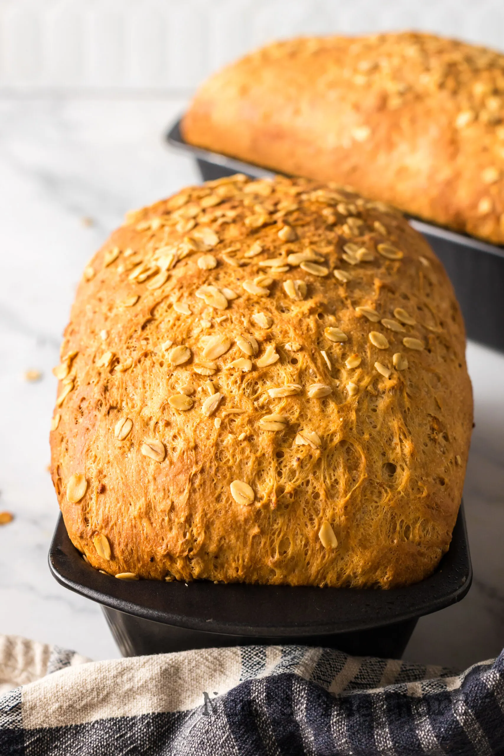 Two loaves of bread in bread pan.