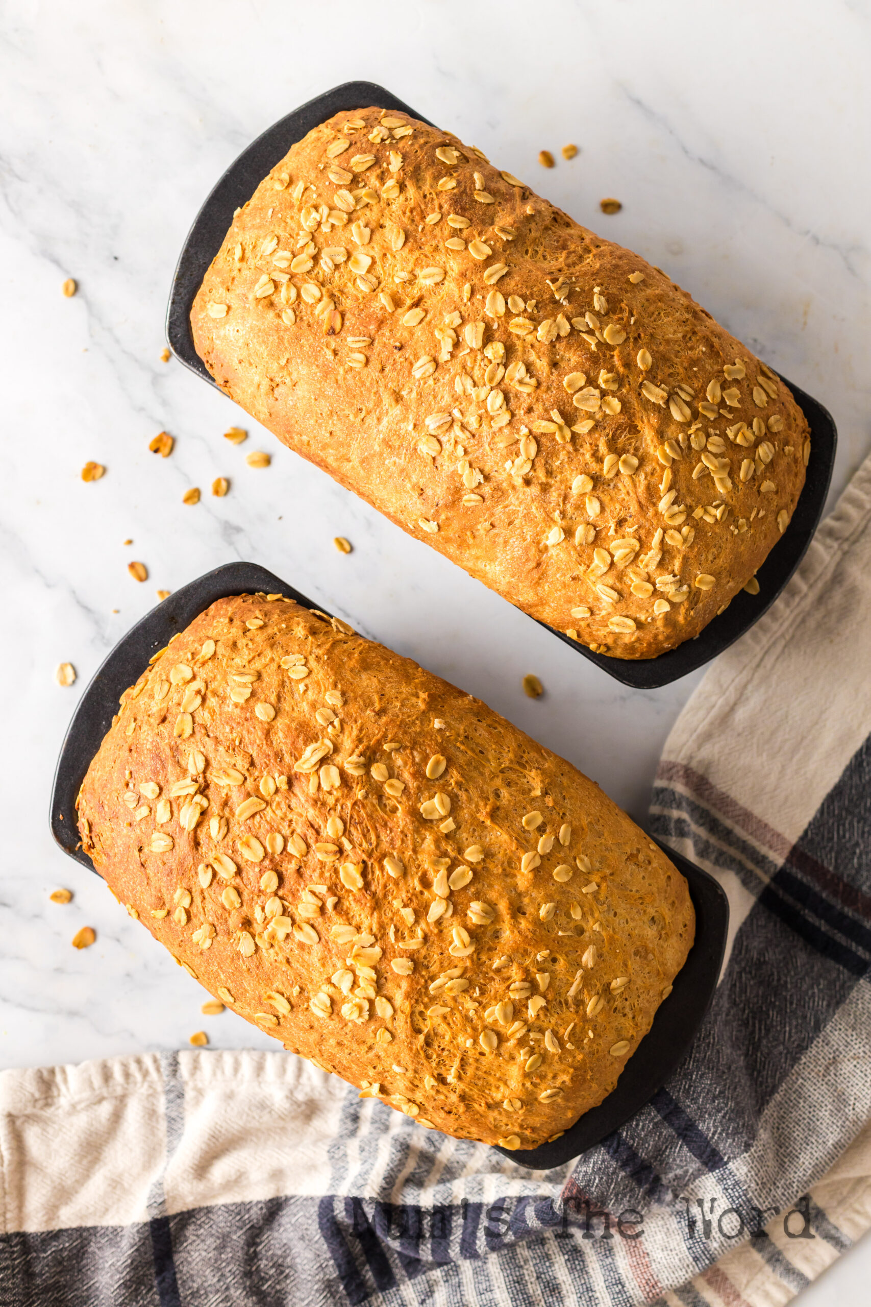top view looking down at two loaves of bread in bread pans, freshly baked.