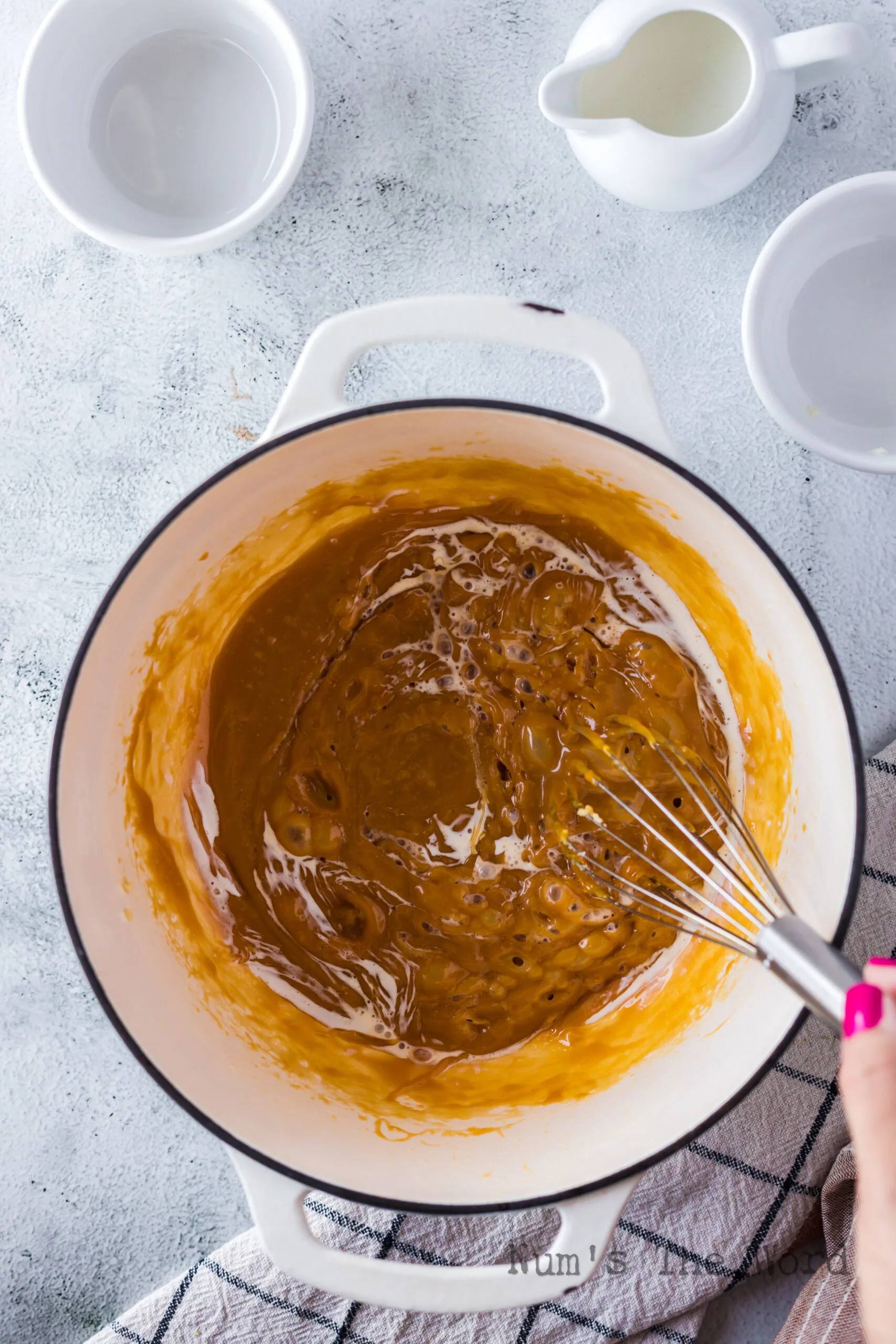 Heavy whipping cream added to caramel sauce