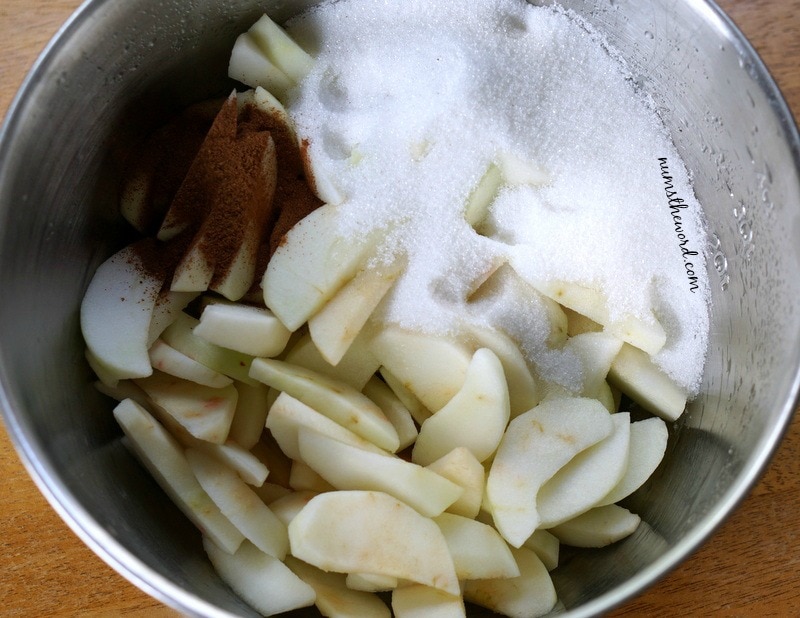 Apple Cobbler Cake - sliced apples and spices in a bowl, not mixed up.