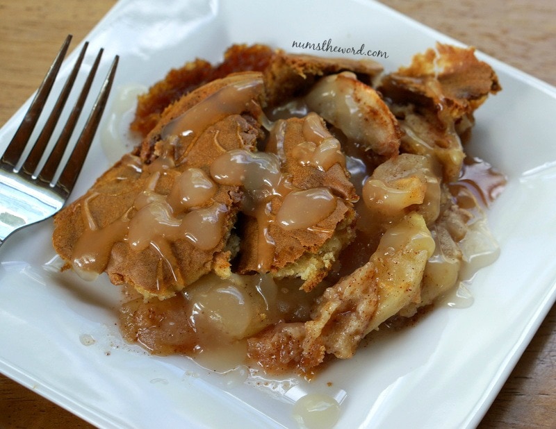 Apple Cobbler Cake - cake on a plate with sauce drizzled on it.