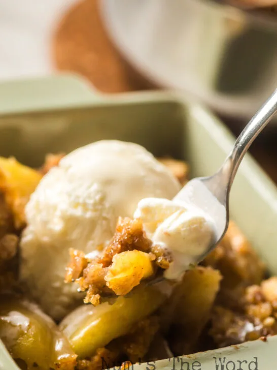 spoon scooping a portion of the cake out of the bowl with a little melted ice cream on it.