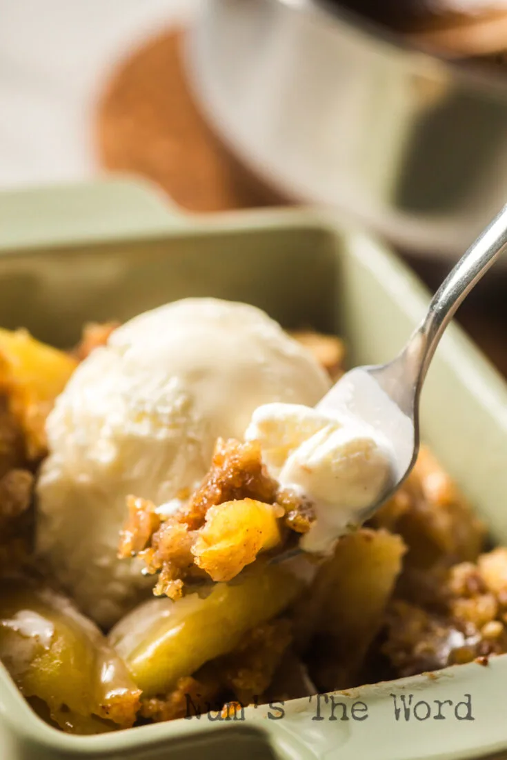 spoon scooping a portion of the cake out of the bowl with a little melted ice cream on it.