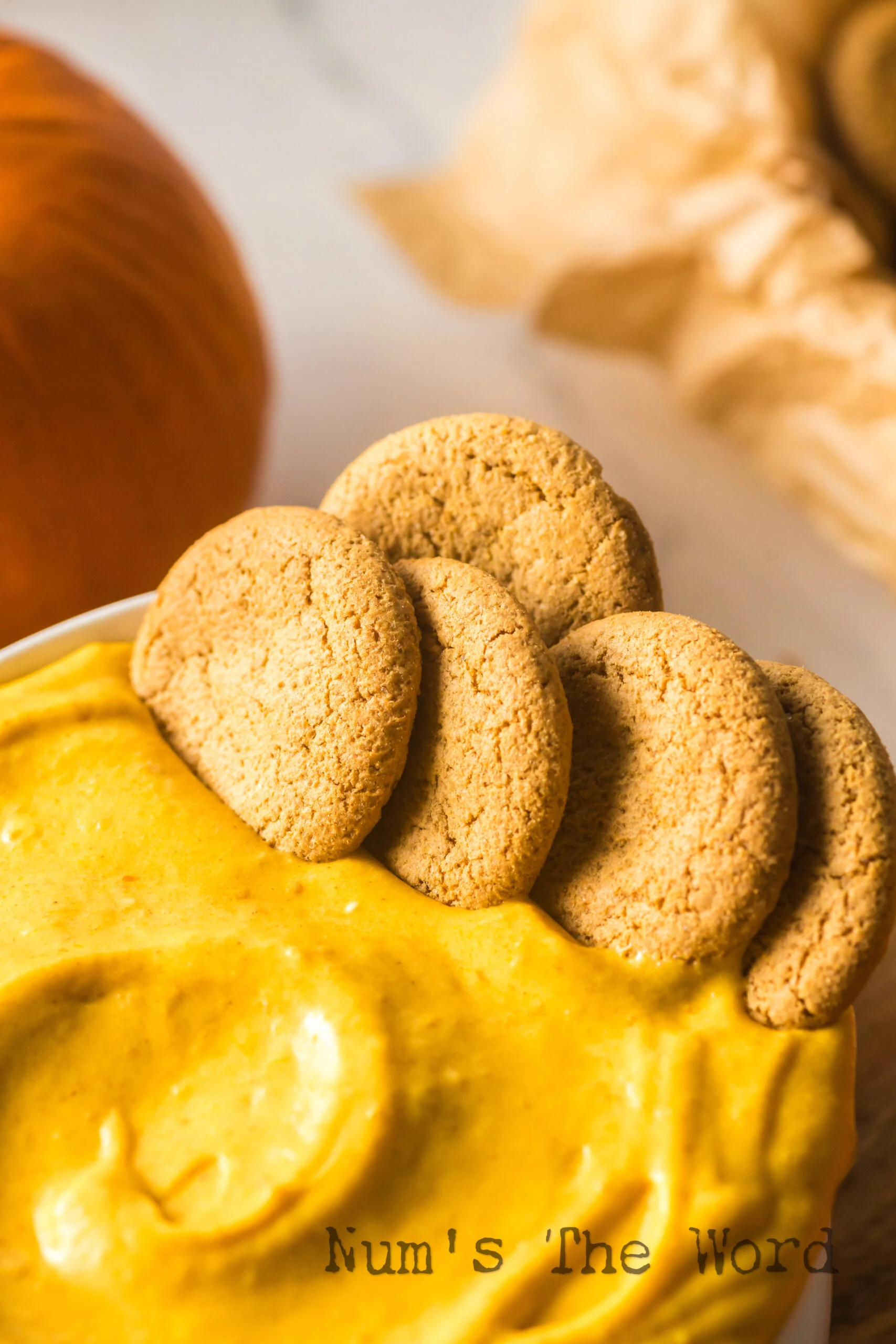 bowl of pumpkin dip with ginger snaps in bowl.