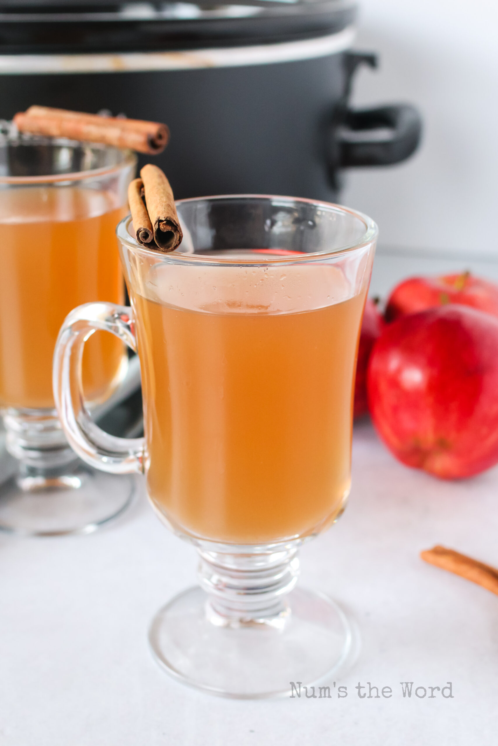 zoomed out image of apple cider in glasses