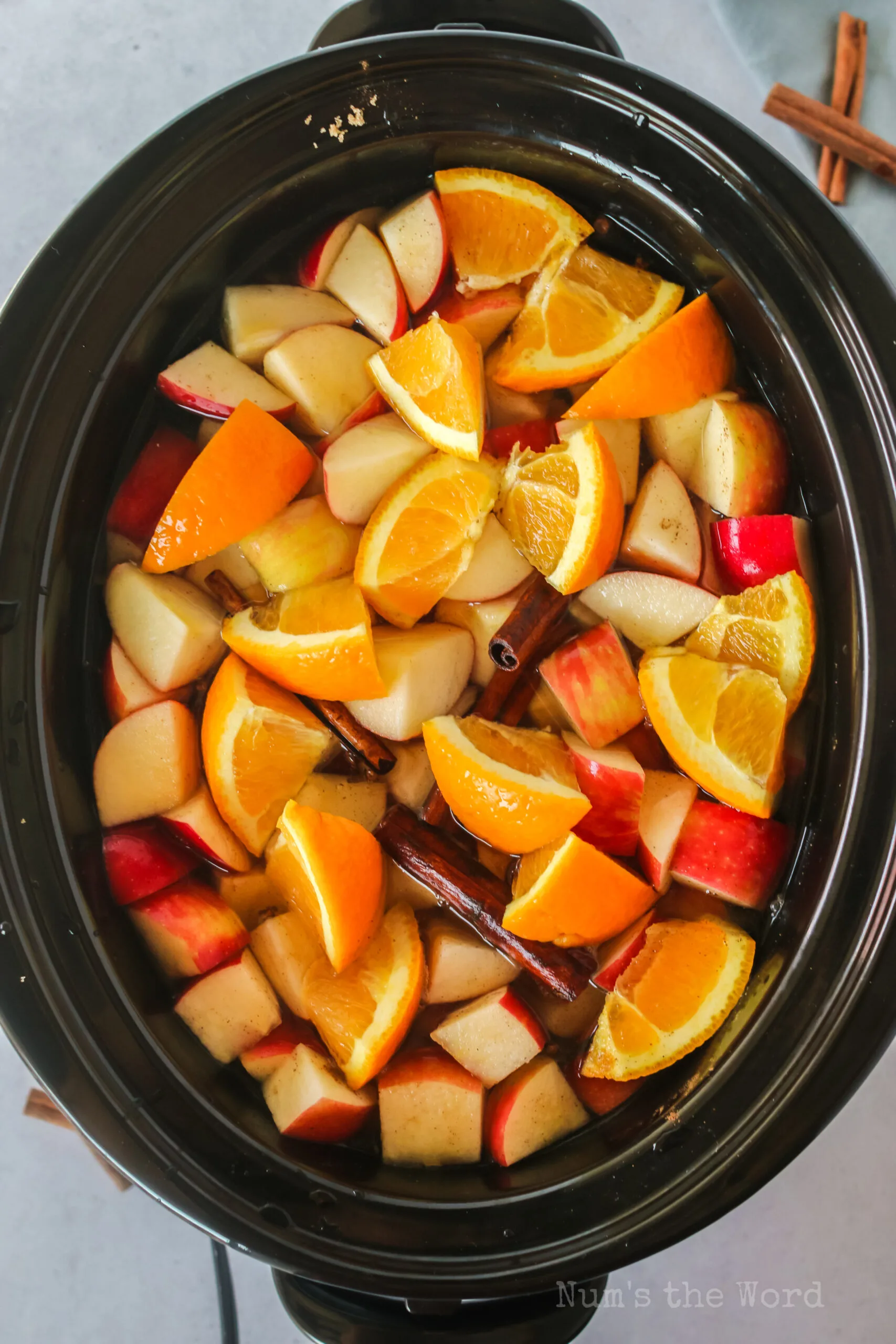 apples, oranges, cinnamon and all other ingredients in crockpot.