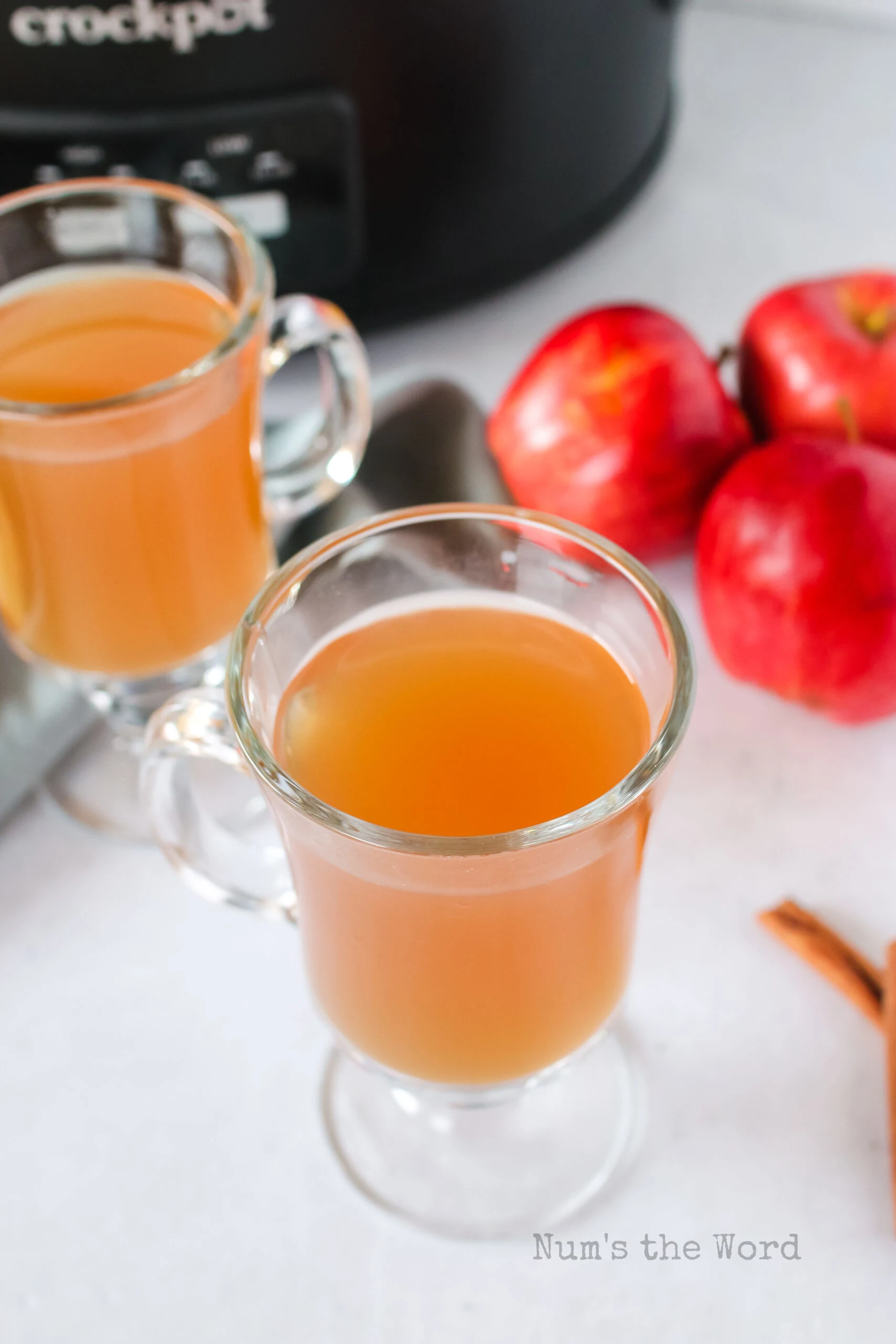 top side angle view of 2 glasses of apple cider