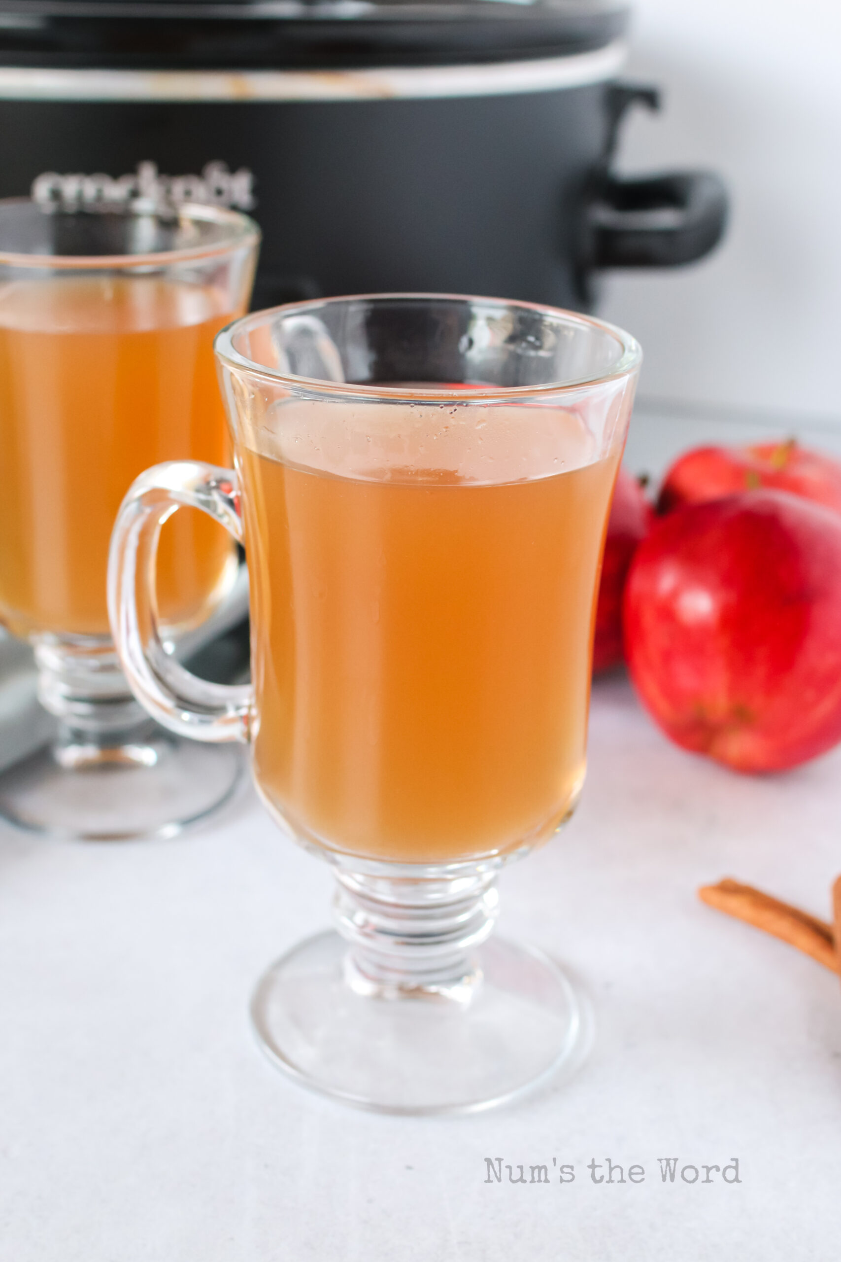 zoomed out view of apple cider in glasses