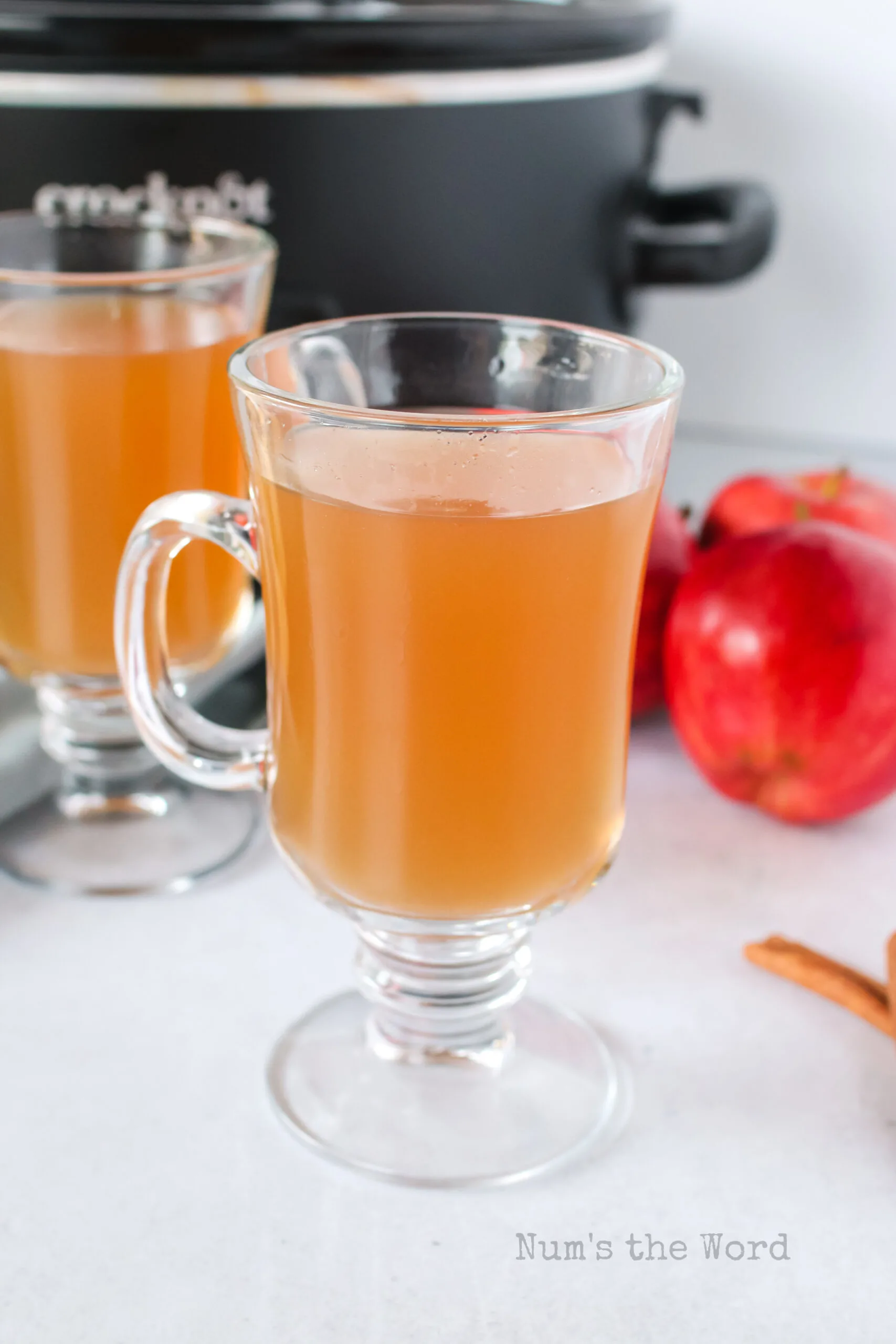 zoomed out view of apple cider in glasses