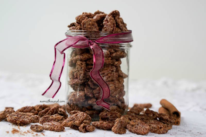 Cinnamon Pecans - side angel of pecans in a glass jar with ribbon