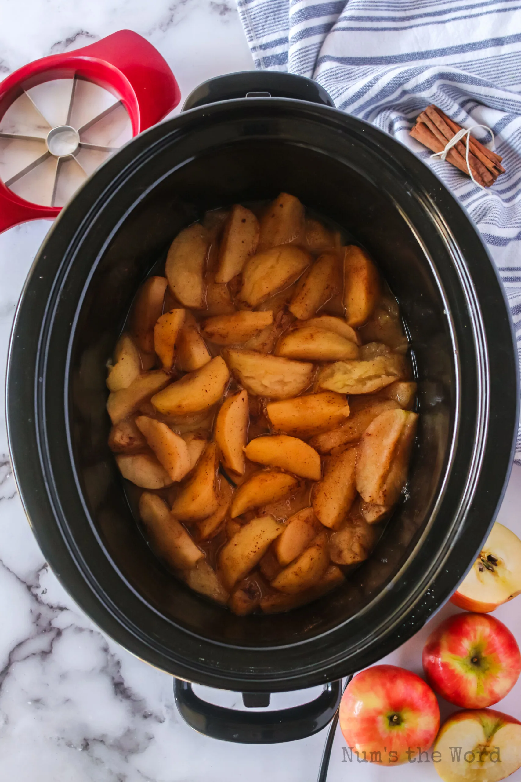 cooked apples in crockpot, ready to mash