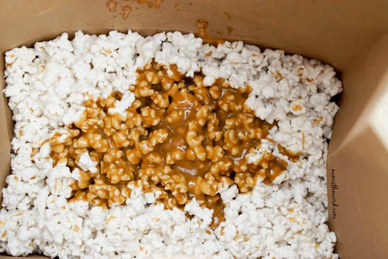 Microwave Caramel Corn - caramel poured on popcorn in paper bag