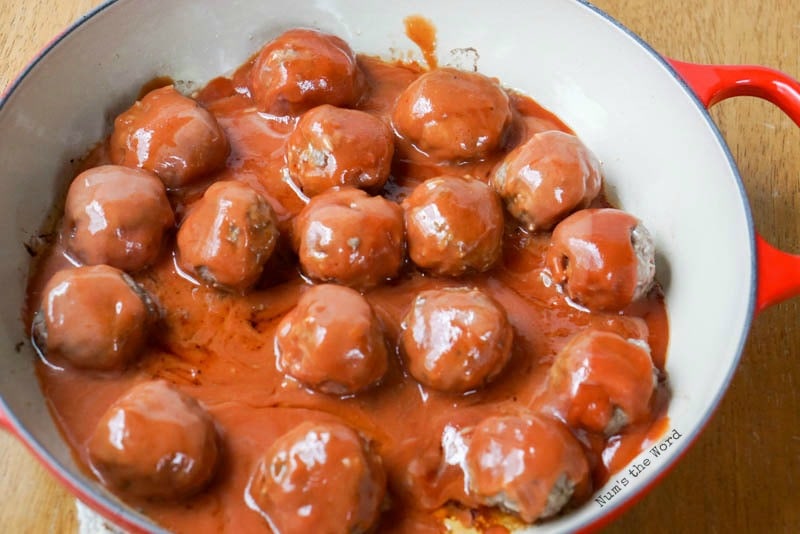 Porcupine Meatballs - Cooked meatballs with tomato sauce over them.