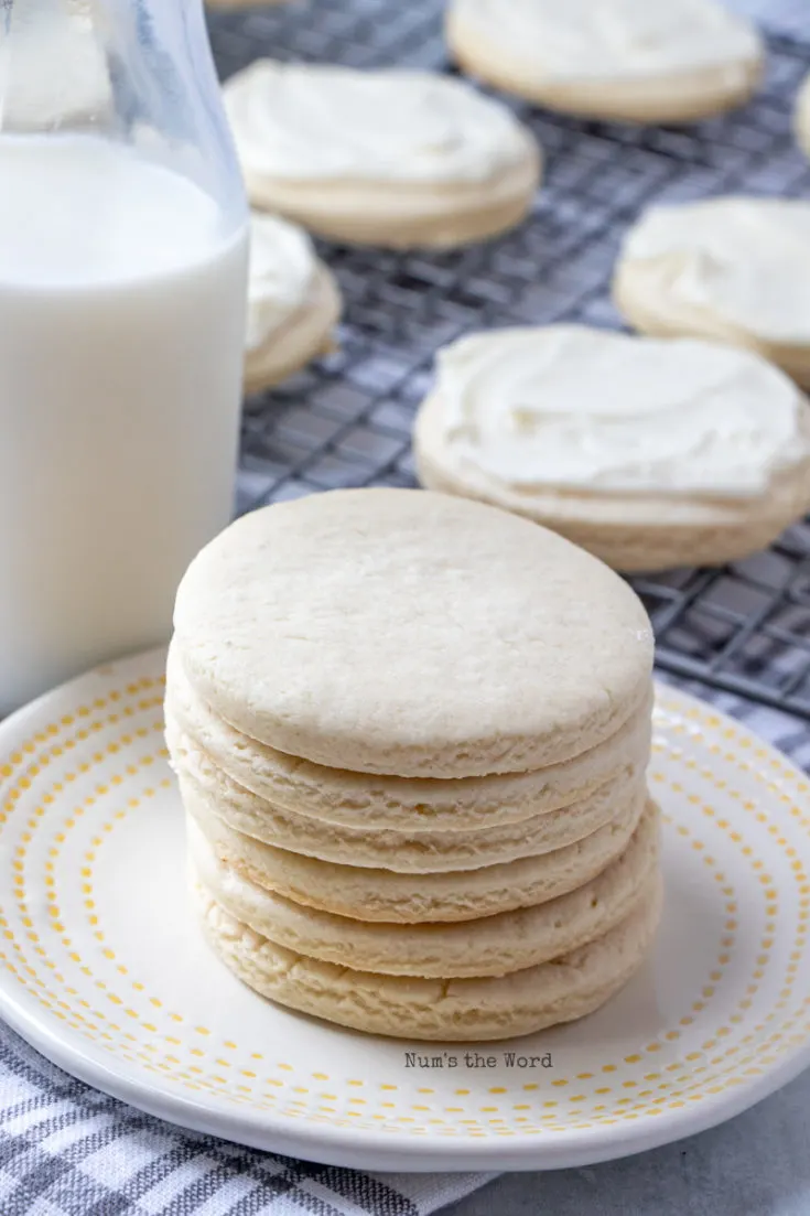 Roll Out Sugar Cookies - baked but unfrosted cookies on plate with glass of milk