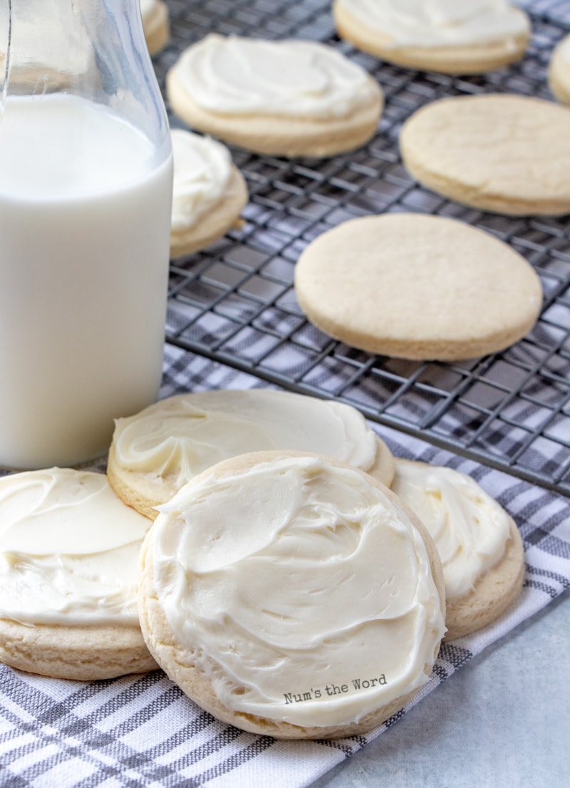 Roll Out Sugar Cookies - frosted cookies next to a glass of milk.