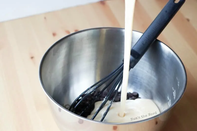 See's Fudge, A Copycat Recipe - showing the marshamallow mixture being poured into the chocolate chips