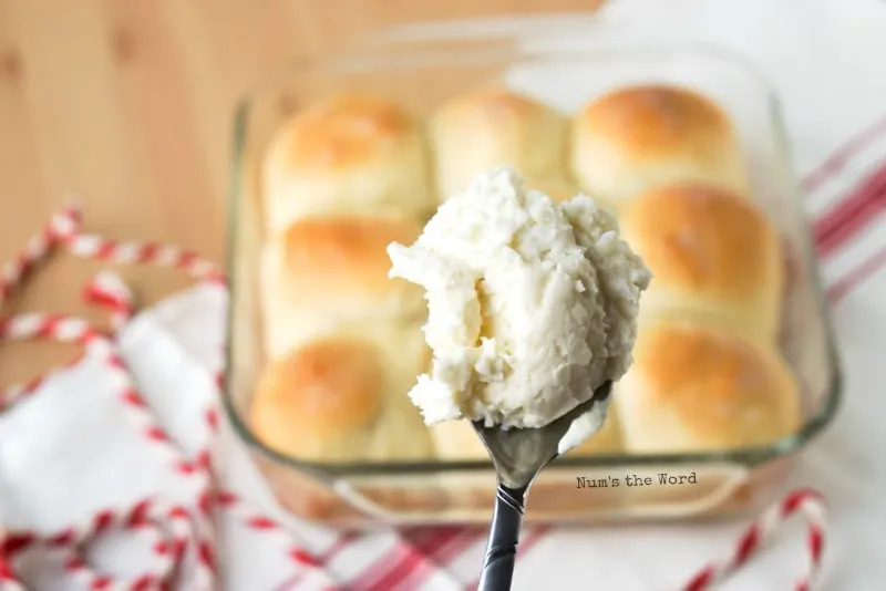 Leftover Mashed Potato Rolls - spoon of mashed potatoes with rolls behind it