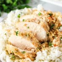 side view of chicken breast sliced and on bed of rice