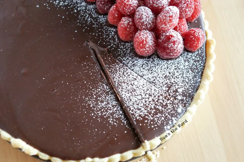 Raspberry Chocolate Tart - a slice cut out but not removed from tart