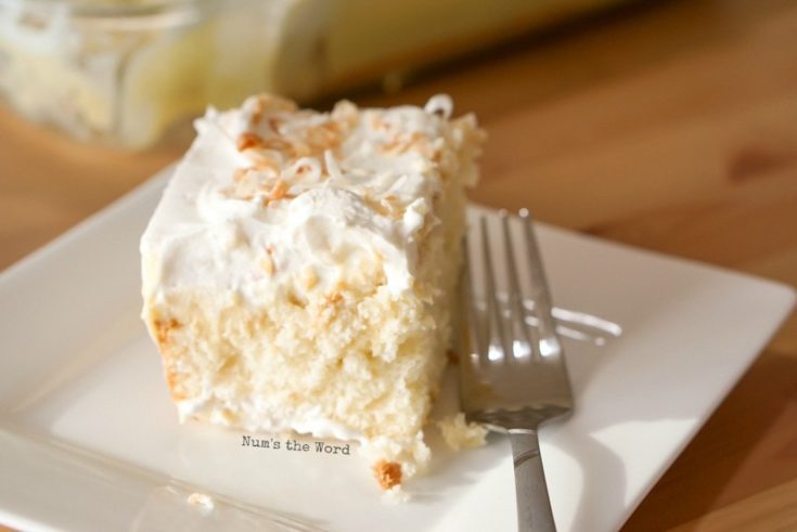 Coconut Cream Pie Poke Cake - sliced cake on plate ready to be eaten!