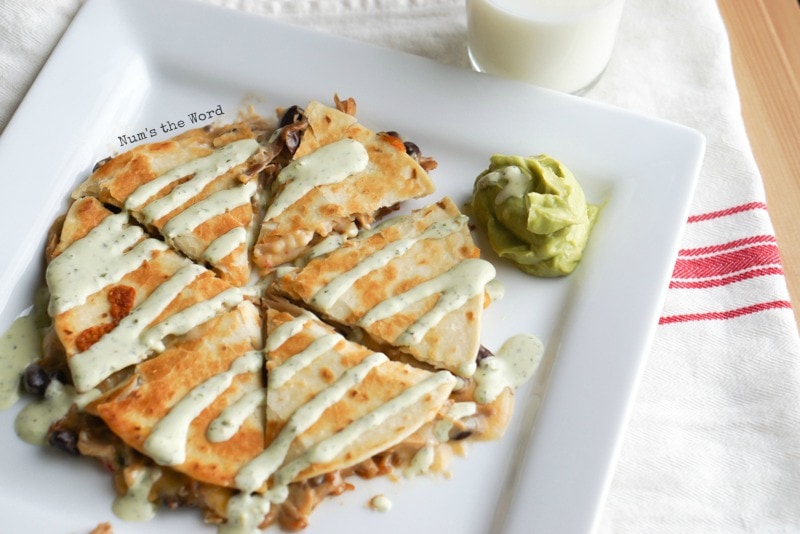 Pulled pork quesadilla with cilantro lime dressing drizzled on top